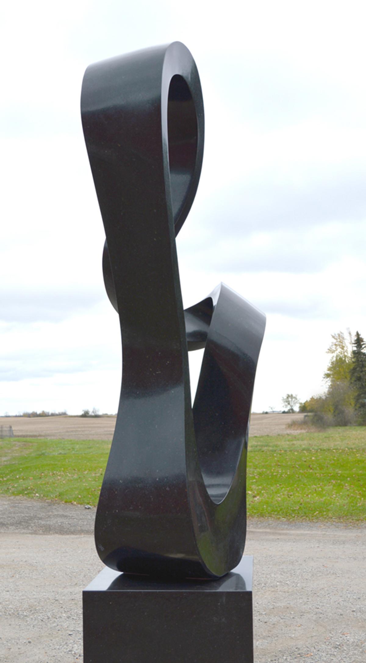 Smooth surfaced, black granite has been engineered into an elegant outdoor sculpture resembling a time signature in music by artist Jeremy Guy. The sculpture weighs approximately 800 pounds.

Jeremy Guy grew up in England where natural inspiration