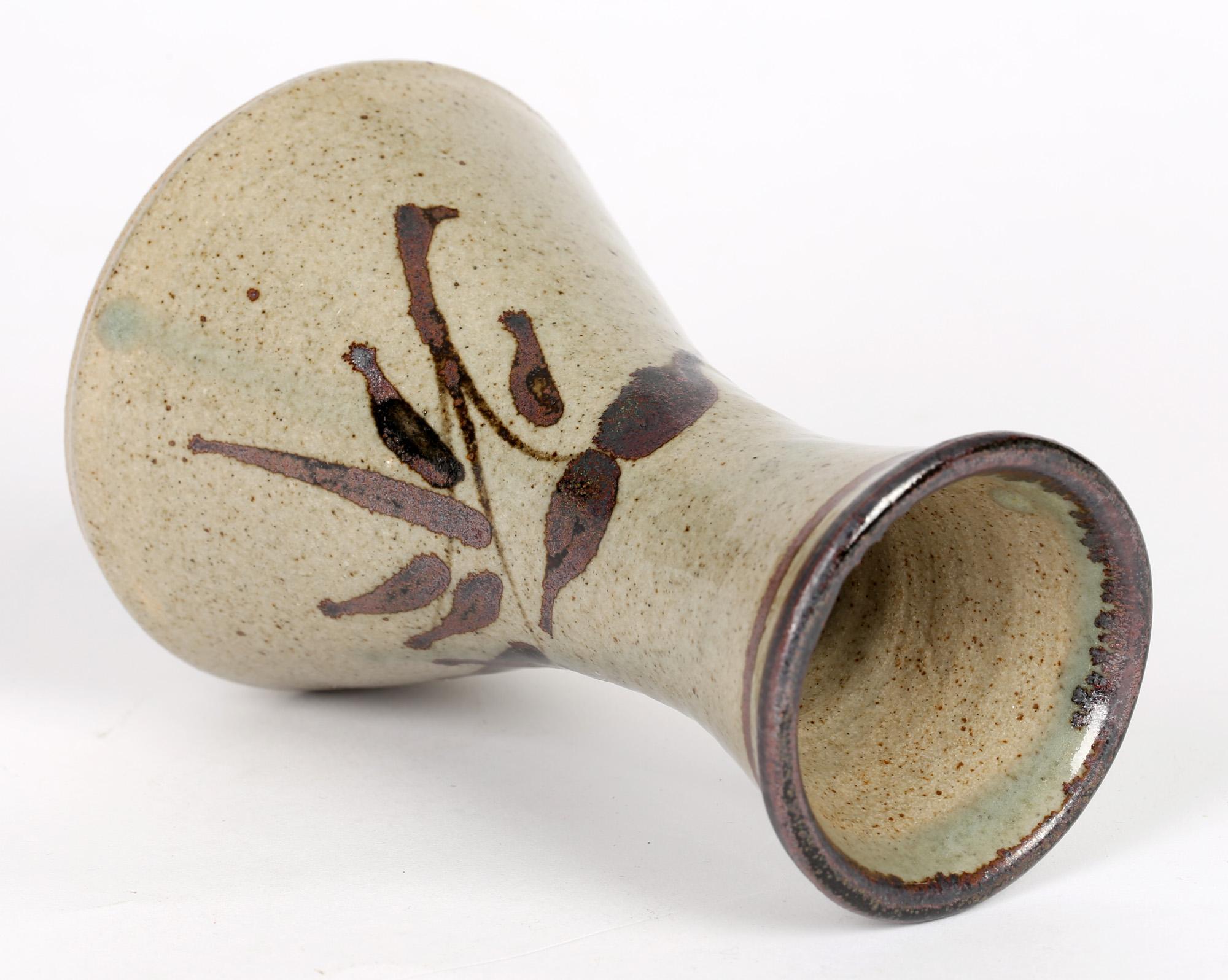 A fine English, Lowerdown Pottery vase with tenmoku glazed designs by Jeremy Leach and Richard Tinnyunt and probably dating from the 1970's. The stoneware vase is of funnel shape with a narrowing neck and flared opening. The vase is decorated with a