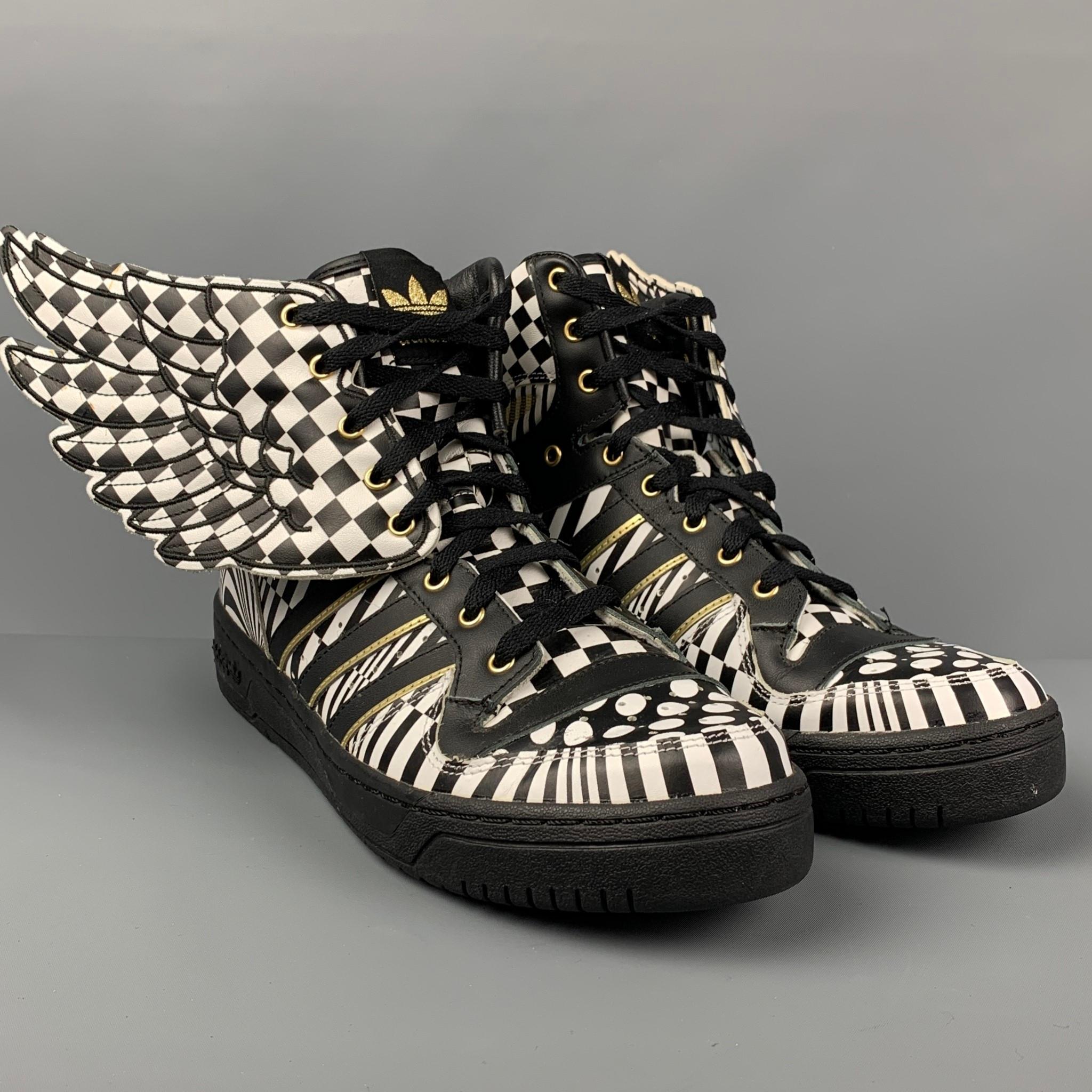 JEREMY SCOTT x ADIDAS sneakers comes in a black & white geometric leather with a gold trim featuring a detachable wing detail, high top, and a lace up closure. 

Very Good Pre-Owned Condition.
Marked: 12

Outsole: 12 in. x 4 in. 