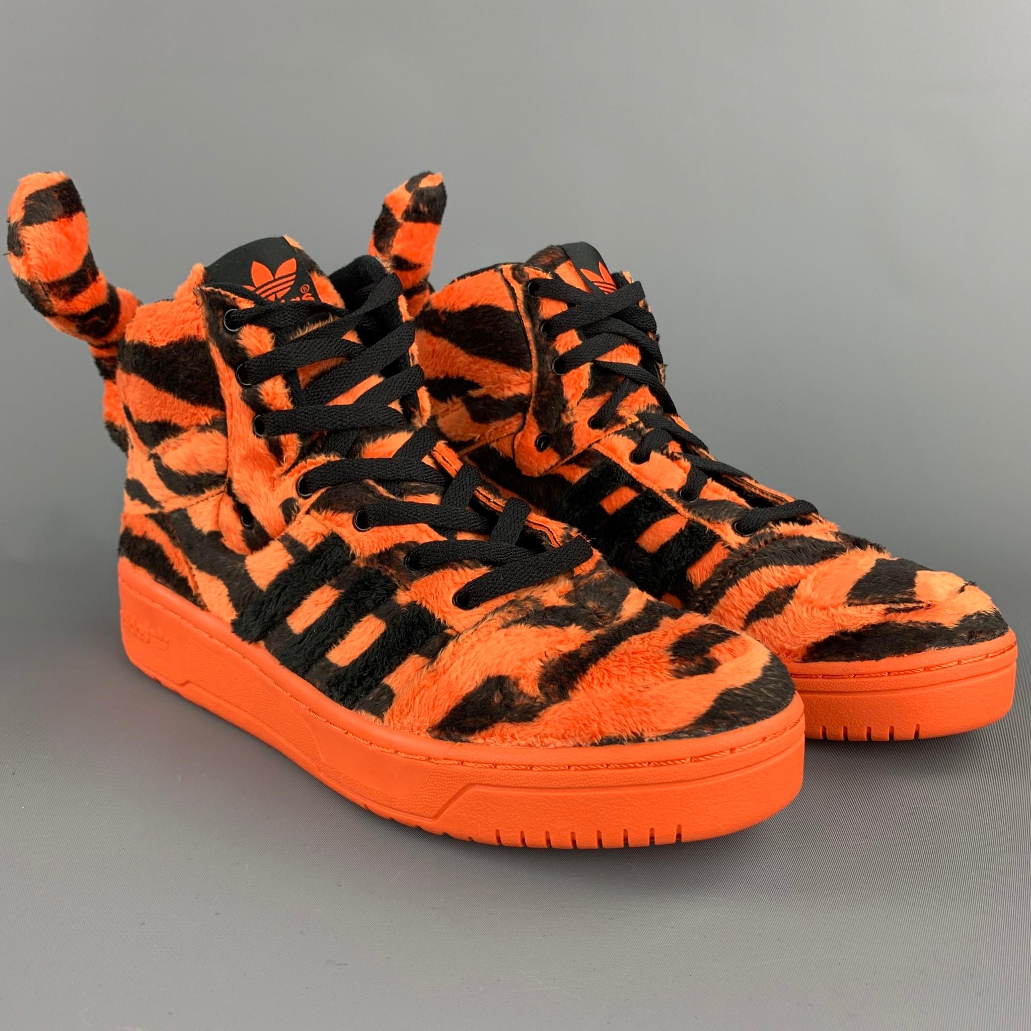 JEREMY SCOTT x ADIDAS sneakers comes orange & black tiger print faux fur featuring a high top style, tail detail, rubber sole, and a lace up closure.

New with box.
Marked: 9

Outsole:  

11.5 in. x 4 in. 