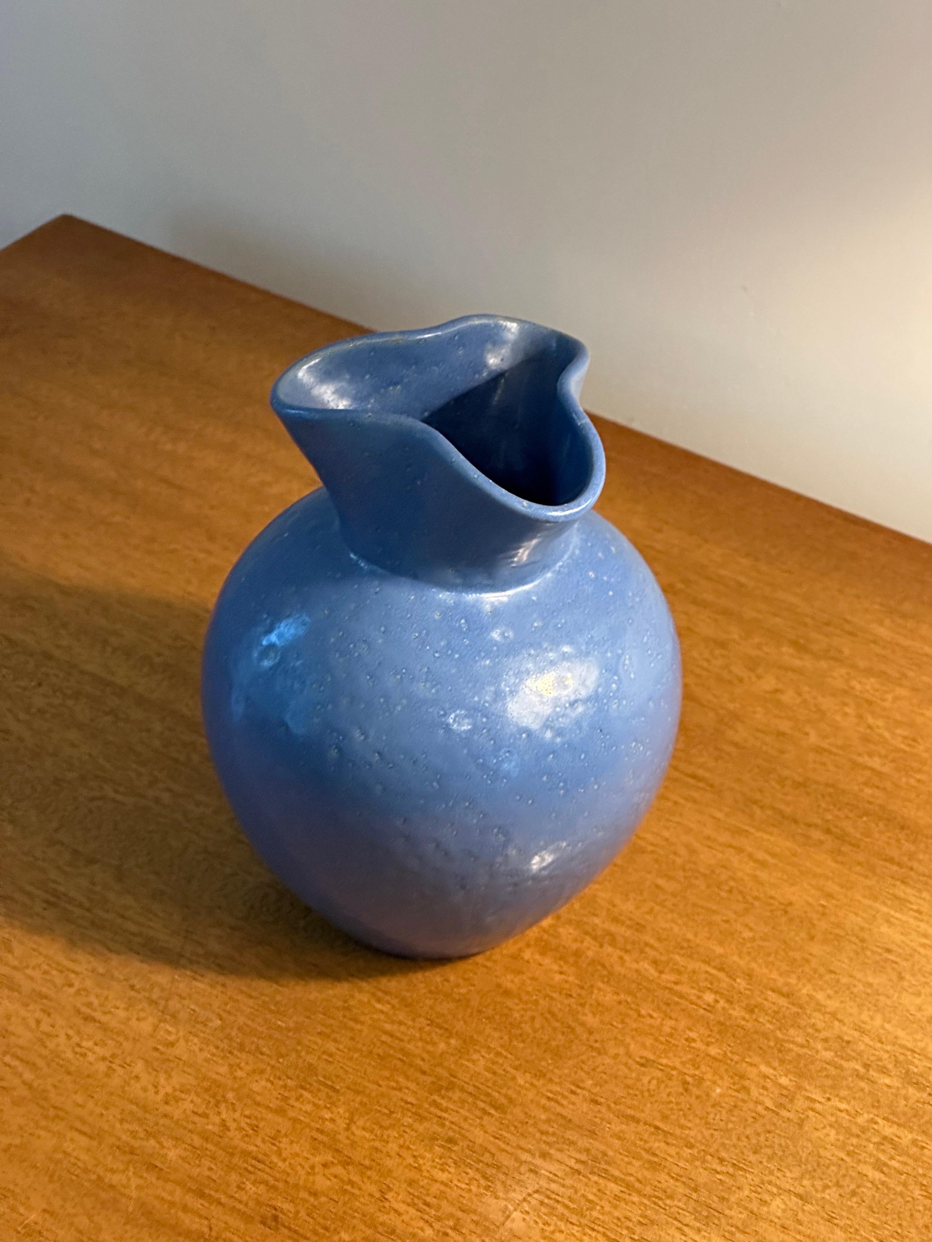 Wonderful blue vase with pinched neck designed by Jerk Werkmäster and produced by Nittsjö. Features a blue body with next textured glaze.  Signed JW on bottom