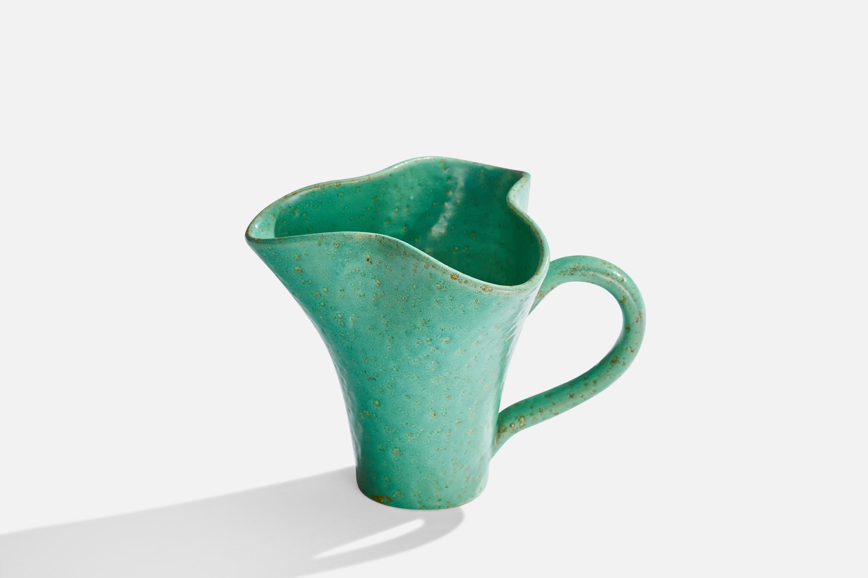 A green-glazed pitcher designed by Jerk Werkmäster and produced by Nittsjö, Sweden, c. 1930s.