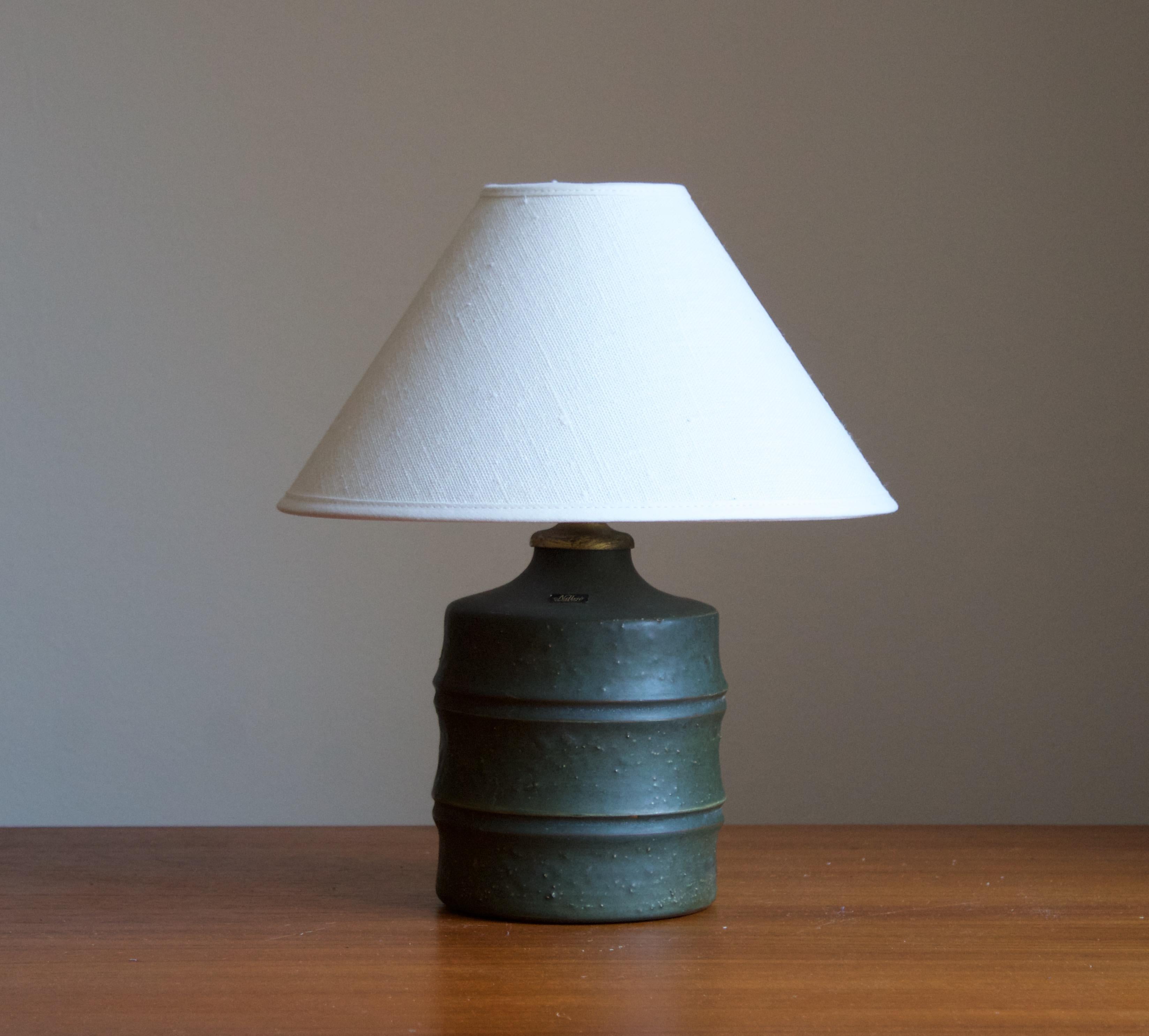 A large modernist table lamp designed by Jerk Werkmäster. Produced by Nittsjö, Sweden, 1930s. Stamped, signed, production labels.

Stated dimensions exclude the lampshade. Sold without lampshade.

Glaze features a green color.

Other designers of