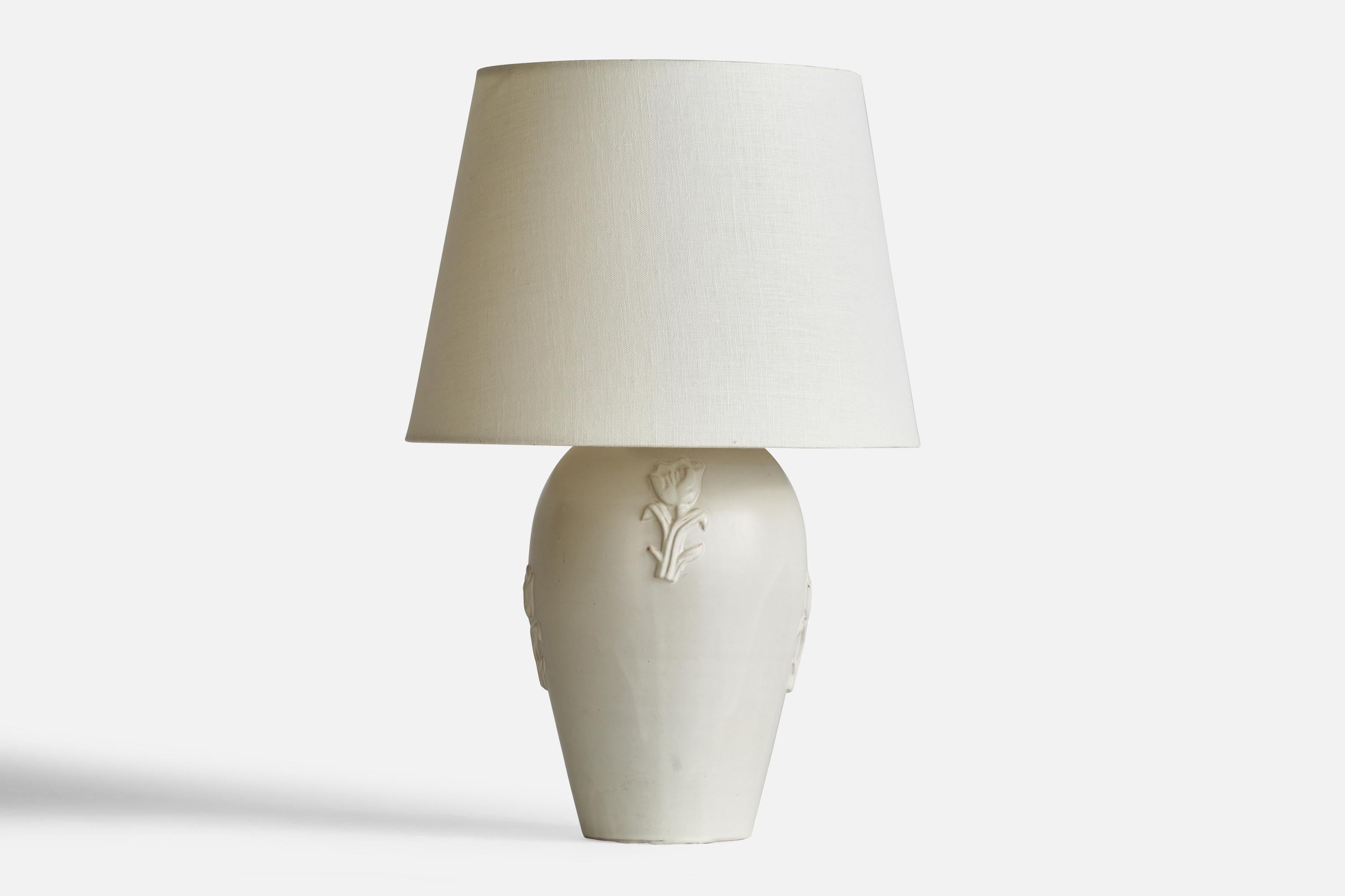 A white-glazed ceramic table lamp designed by Jerk Werkmäster and produced by Nittsjö, Sweden, 1930s.

Dimensions of Lamp (inches): 12.1” H x 6.35” Diameter
Dimensions of Shade (inches): 9” Top Diameter x 12” Bottom Diameter x 9” H
Dimensions of