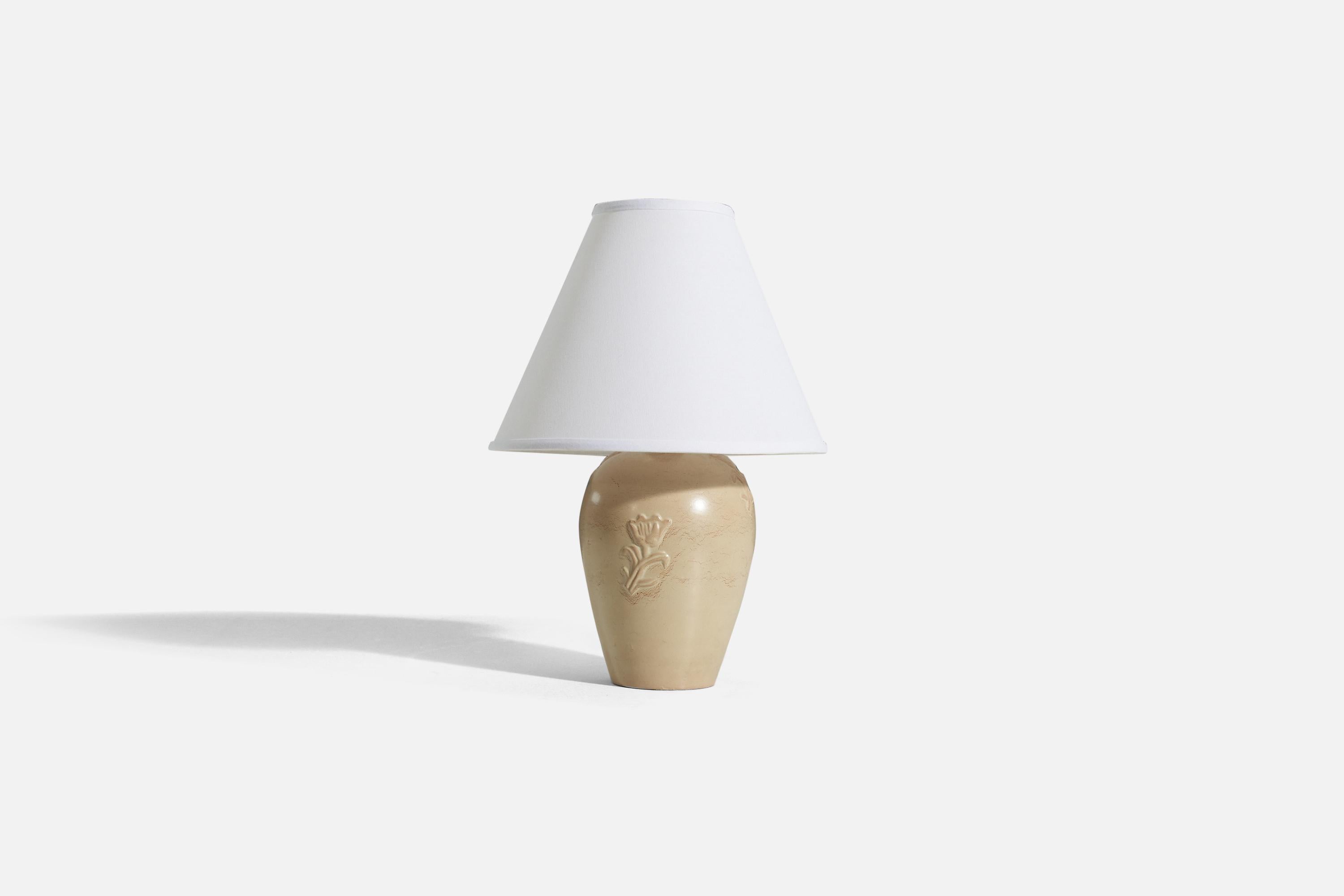 A cream-glazed earthenware table lamp with flower bas relief decor, designed by Jerk Werkmäster and produced by Nittsjö Ceramics, Sweden, c. 1940s. 

Sold without lampshade. 
Dimensions of Lamp (inches) : 10.25 x 5 x 5 (H x W x D)
Dimensions of