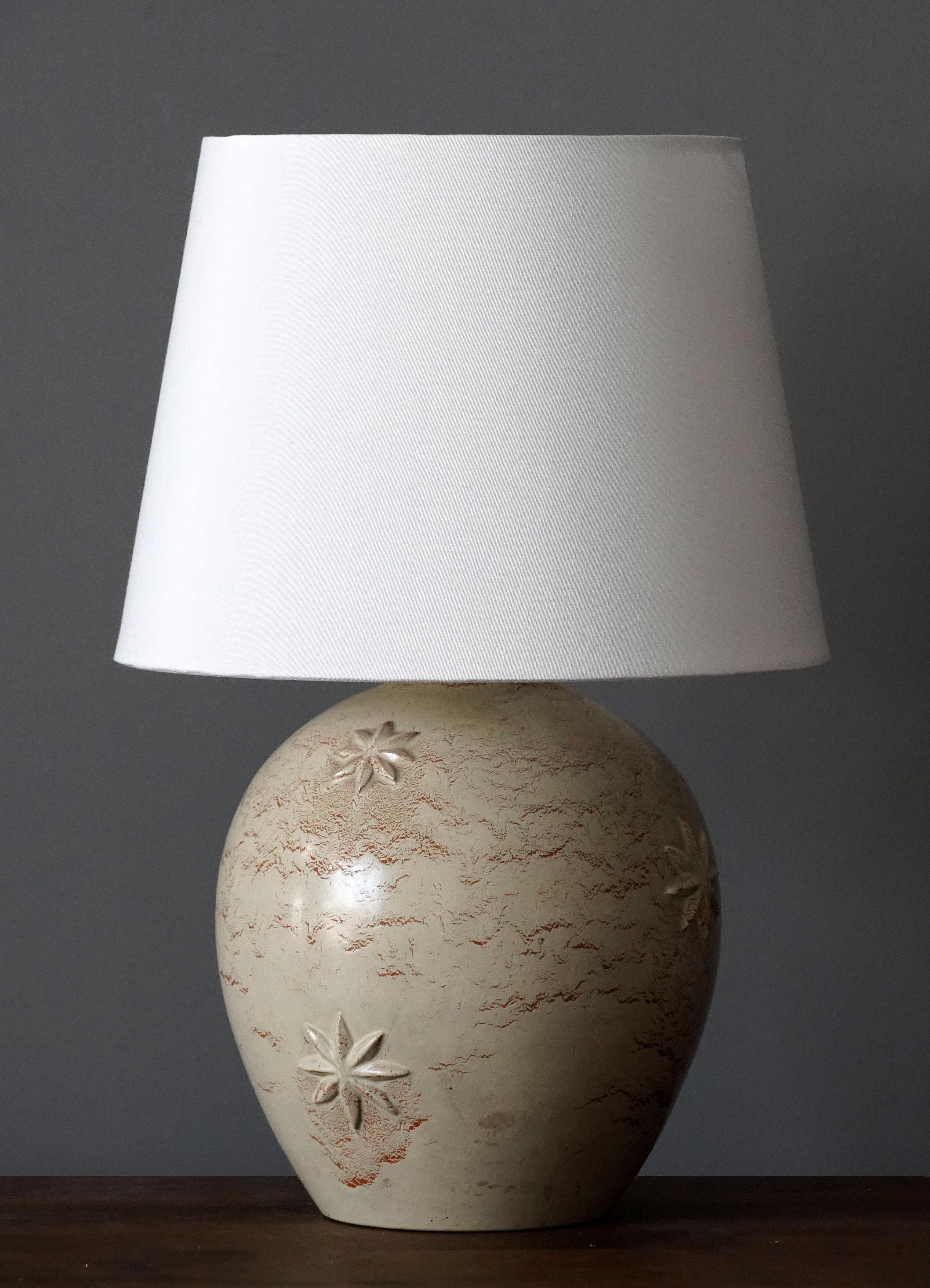 A table lamp designed by Jerk Werkmäster. Produced by Nittsjö, Sweden, 1950s. Stamped.

Sold without lampshade. Stated measurements exclude lampshade.

Glaze features brown-beige-grey colors.

Other designers of the period include Axel Salto, Paavo