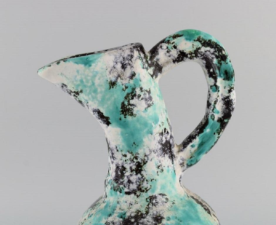 Jerome Massier (1850-1916) for Vallauris. 
Antique freeform pitcher in glazed stoneware. Beautiful polychrome glaze. 
Early 20th century.
Measures: 31 x 20 cm.
In excellent condition.
Stamped.