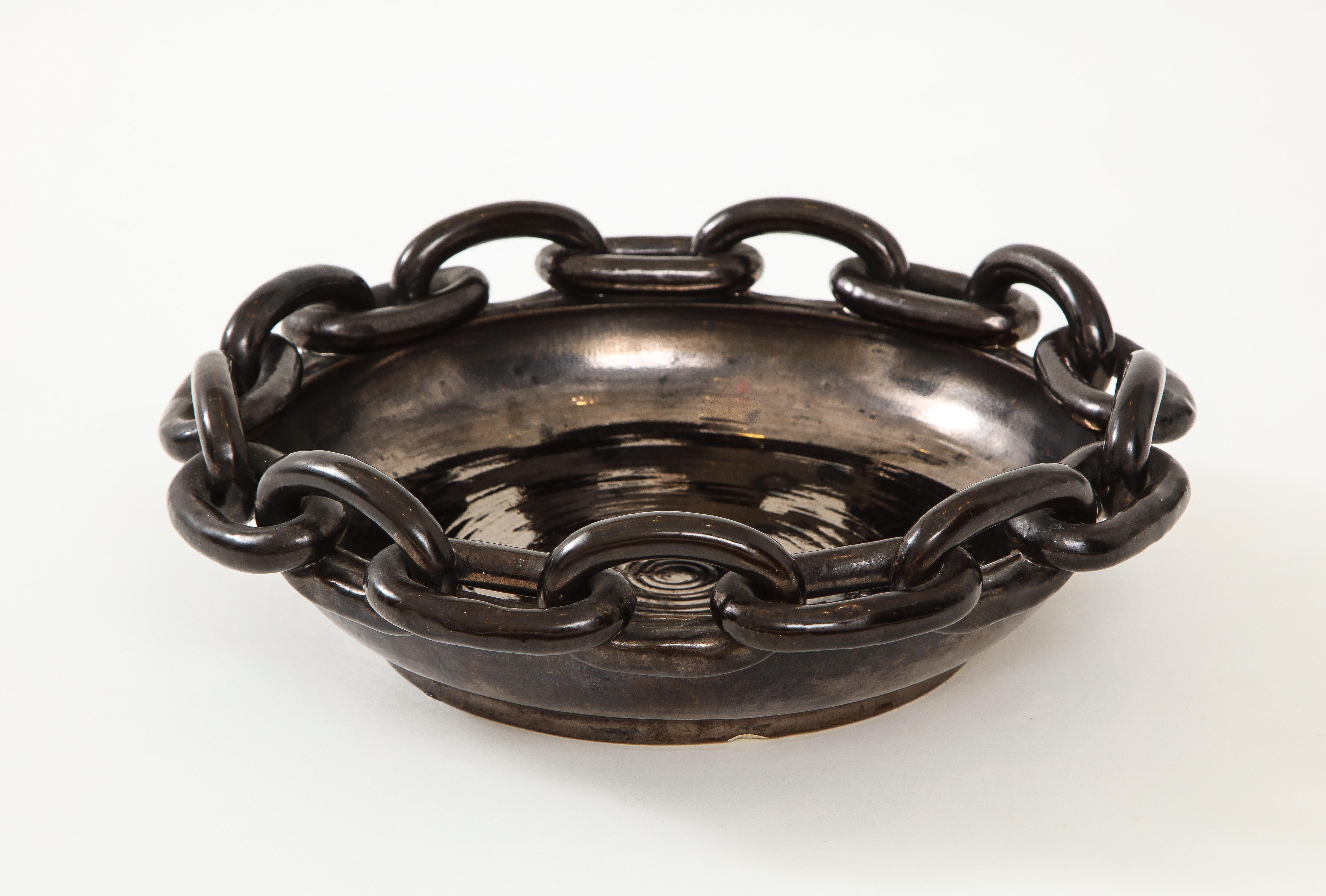 Signed large black ceramic circular bowl with chain link, detail by Jerome Massier, Vallauris, France, circa 1950.