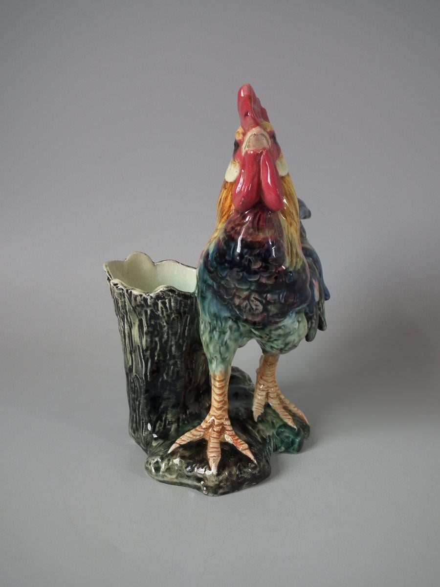 Jerome Massier Fils Majolica vase which features a cockerel/rooster stood in front of a tree stump. Coloration: ochre, puce, blue, are predominant. The piece bears maker's marks for the Jerome Massier Fils pottery.