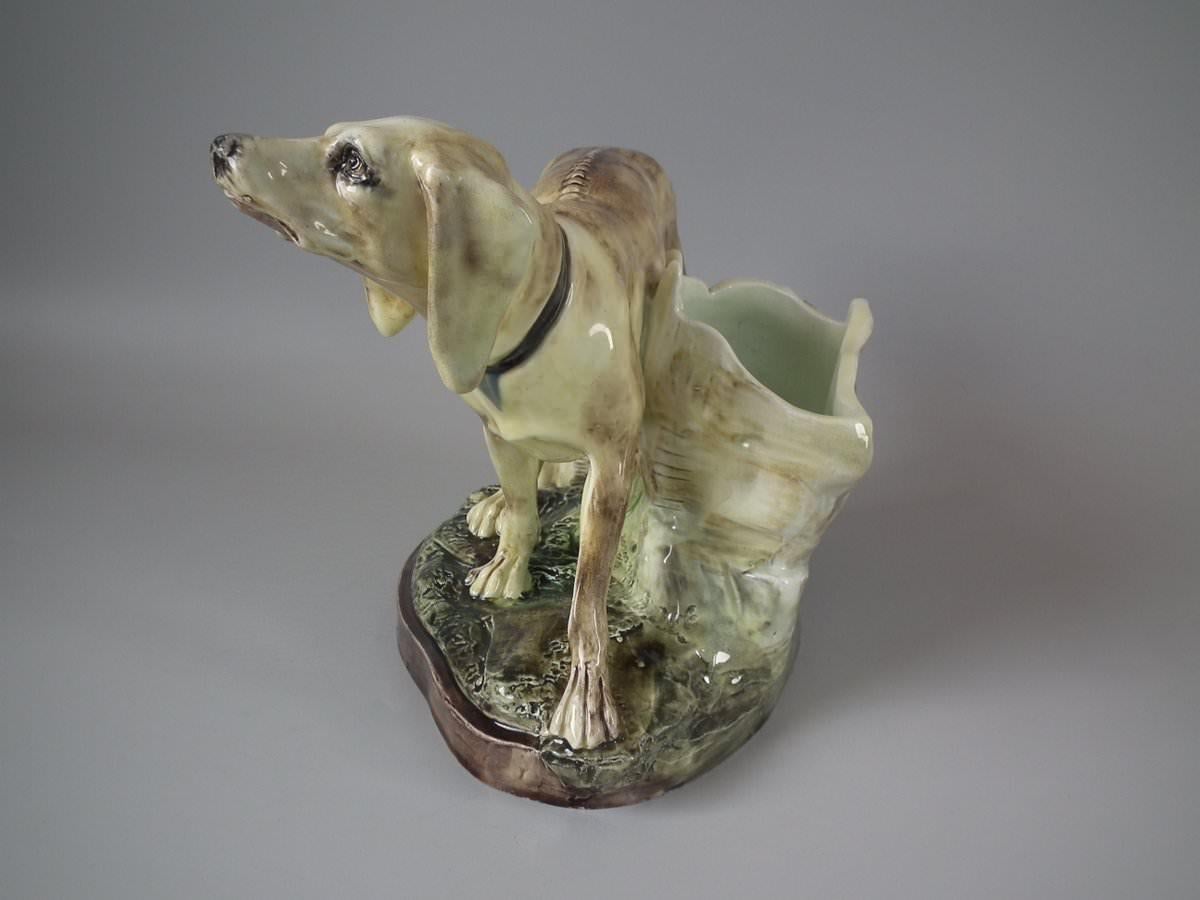 Jerome Massier Fils French Majolica vase which features a hunting dog stood in front of a tree trunk. Coloration: cream, brown, green, are predominant. The piece bears maker's marks for the Jerome Massier Fils pottery. Book reference, 'Barbotines de