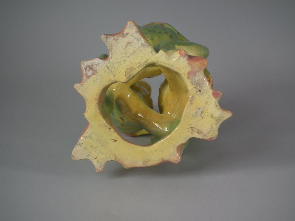 Jerome Massier French Majolica posy holder which features three dancing frogs with open mouths. Colouration: green, ochre, pink, are predominant. Book reference, 'Barbotines de la Côte d'Azur' by Marsee Bottero, page 88, figure 3.