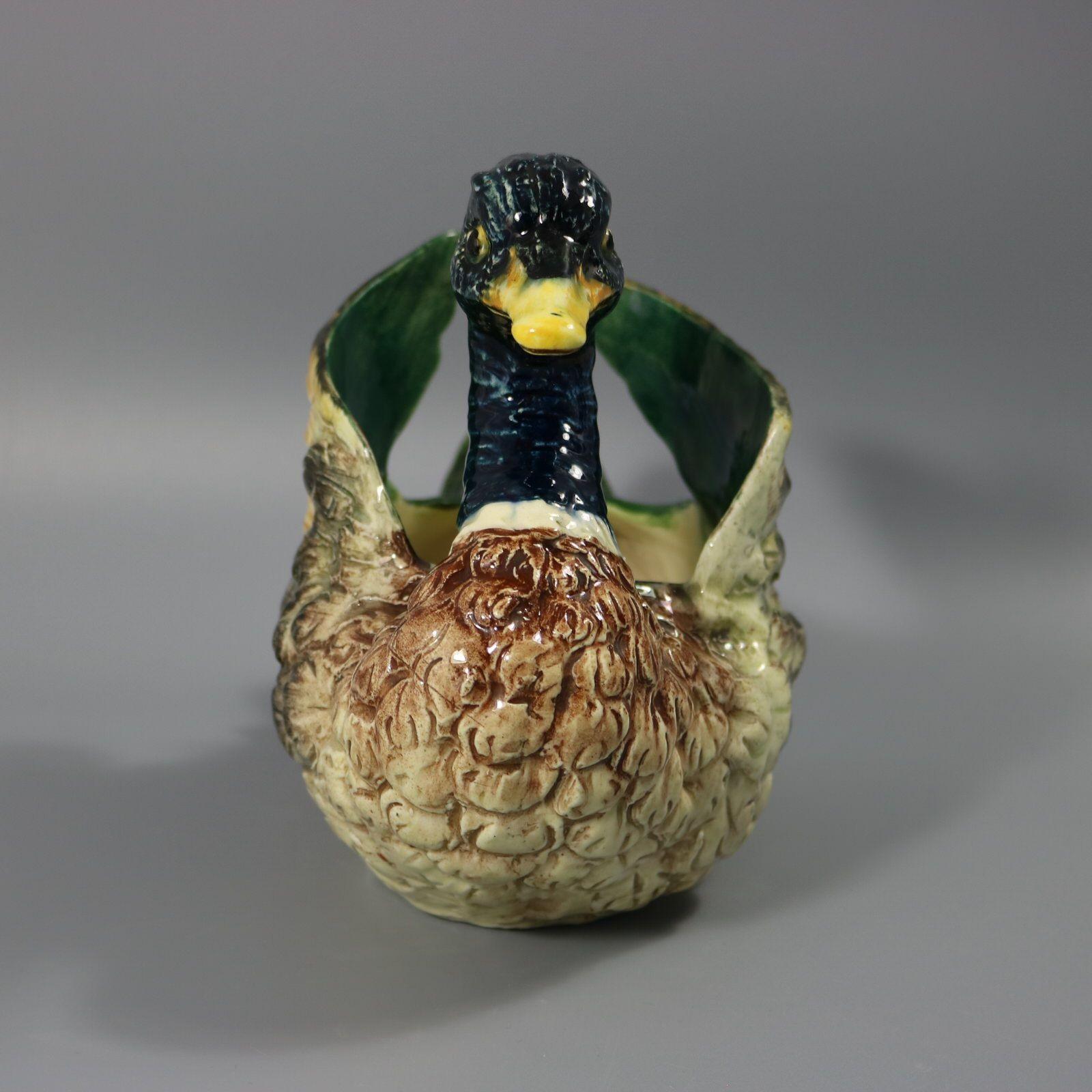 Jerome Massier French Majolica planter which features a mallard duck in a swimming posture, wings curled up behind. Colouration: teal blue, cream, green, are predominant. The piece bears maker's marks for the Jerome Massier pottery.