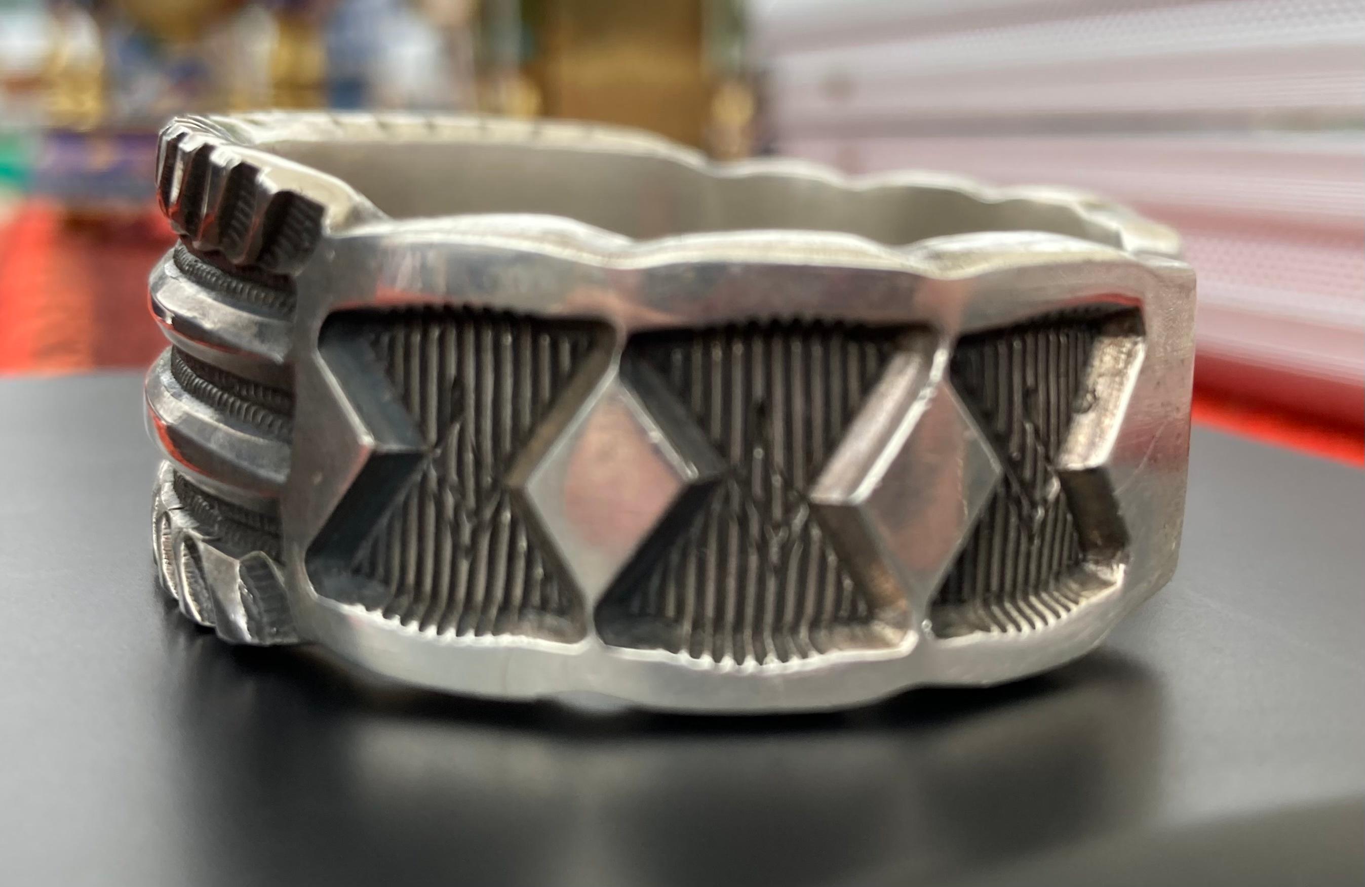 This cuff is one of my favorite pieces to be able to present. It's an impressive 118.5g of sterling silver. Jerrold Tahe hand stamps his pieces using a four pound ball peen hammer and each piece is unique. This one-of-a-kind heavyweight will dress