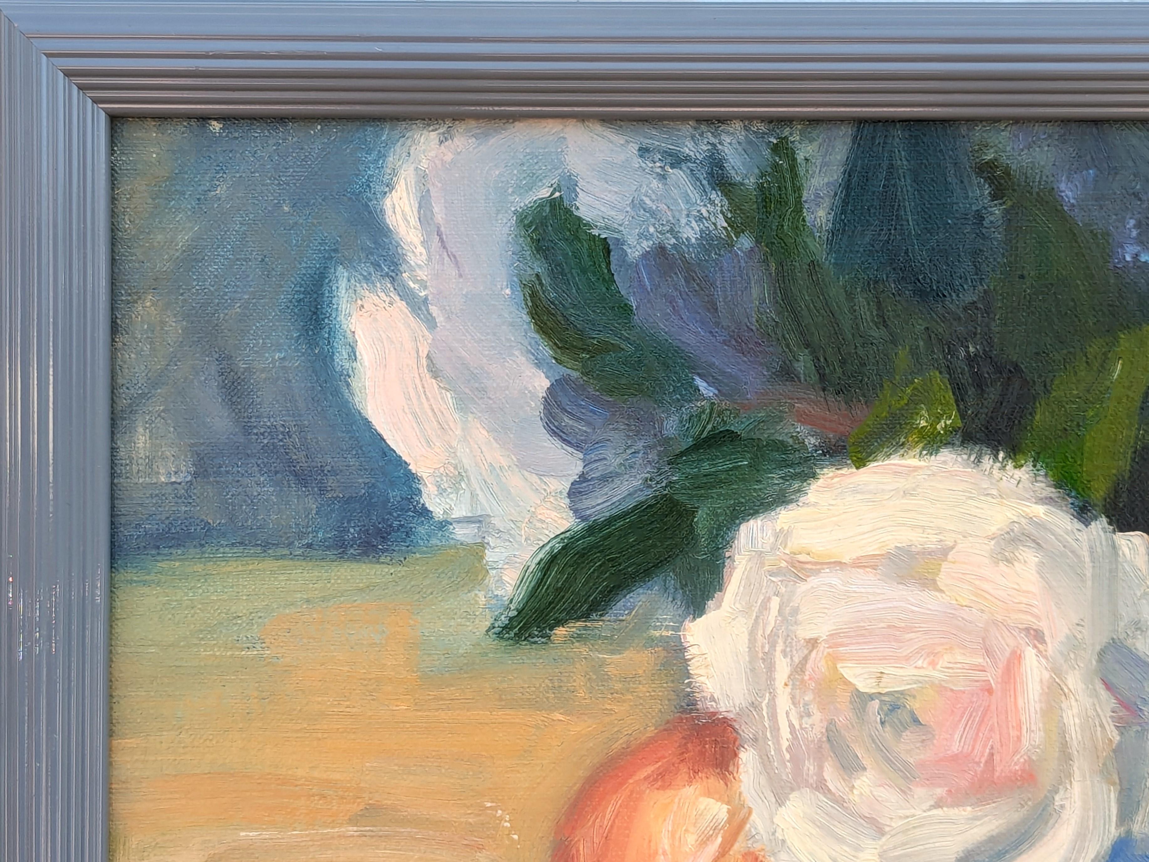 Contemporary realistic still life painting by Houston based artist Jerry Greenberg. The work features a group of apples arranged next to a bouquet of light pink flowers. Signed in the front lower right corner. Currently hung in a grey frame.