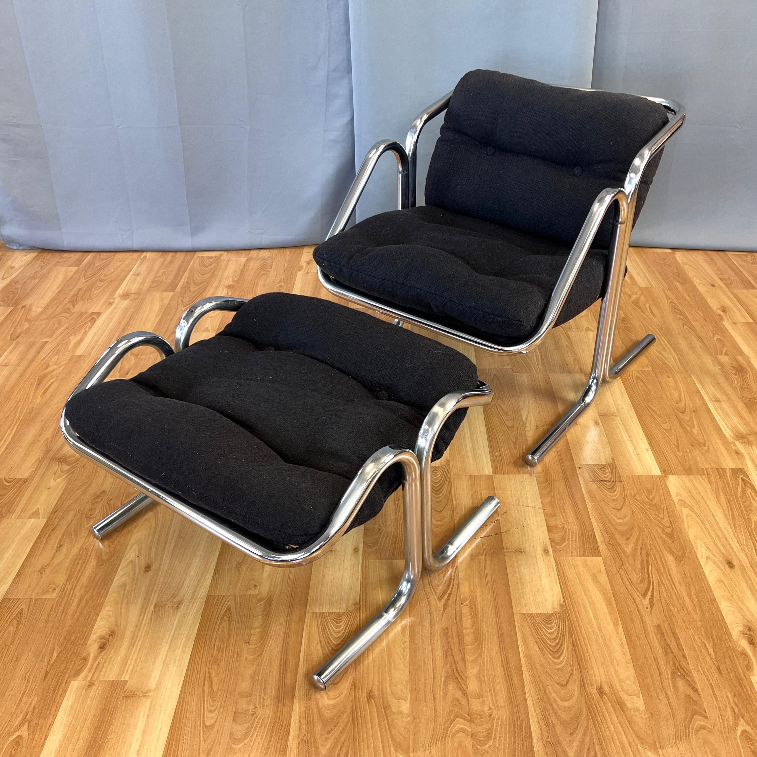 A 1972 Jerry Johnson for Landes Manufacturing Co. Arcadia tubular chrome lounge chair and footstool or ottoman set with original black fabric upholstery.

Chrome-plated tubular steel two-piece frames on both the chair and footstool feature