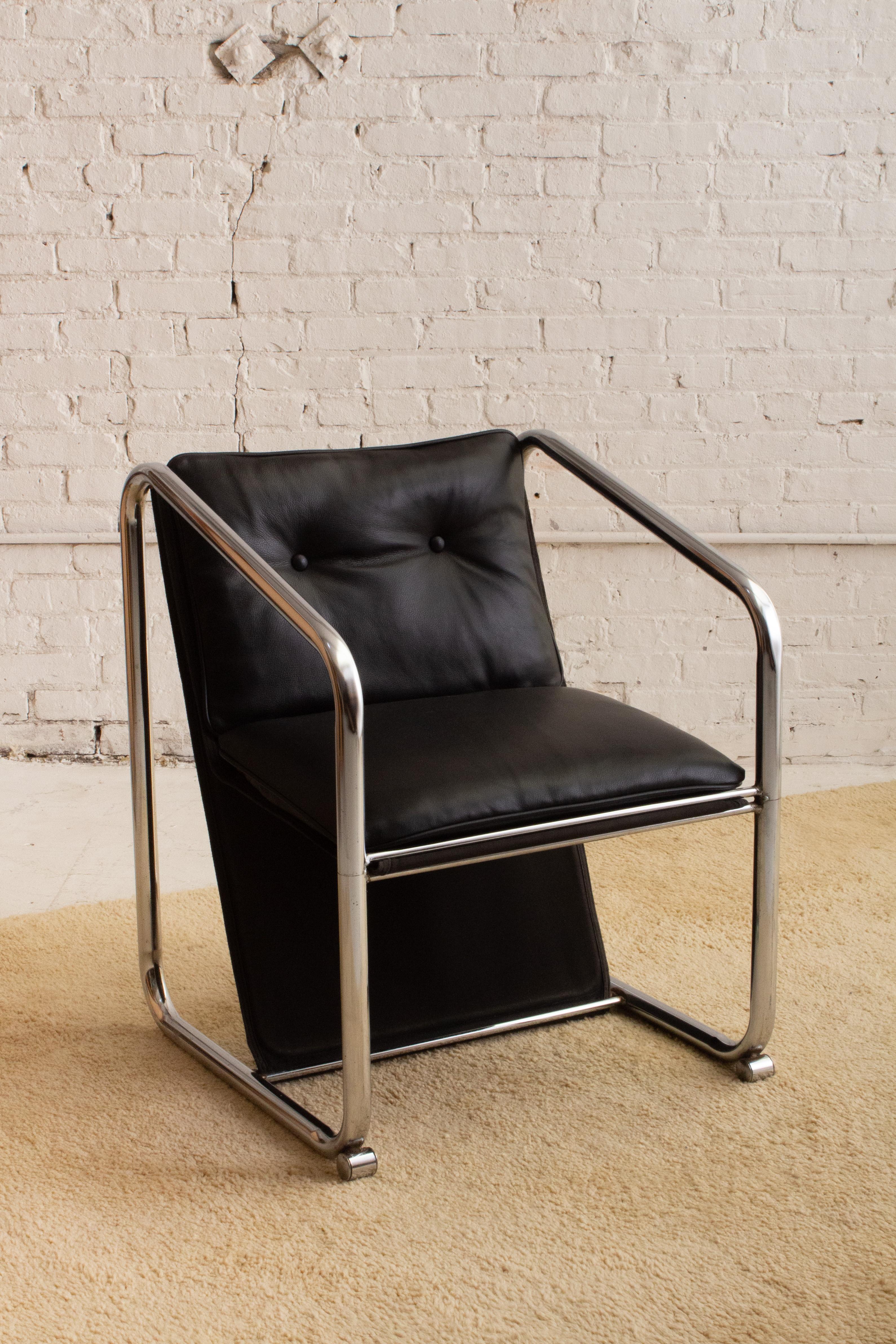 A mid century modern chrome sling chair attributed to Jerry Johnson. Chrome frame with original canvas sling and newly added black leather cushion.