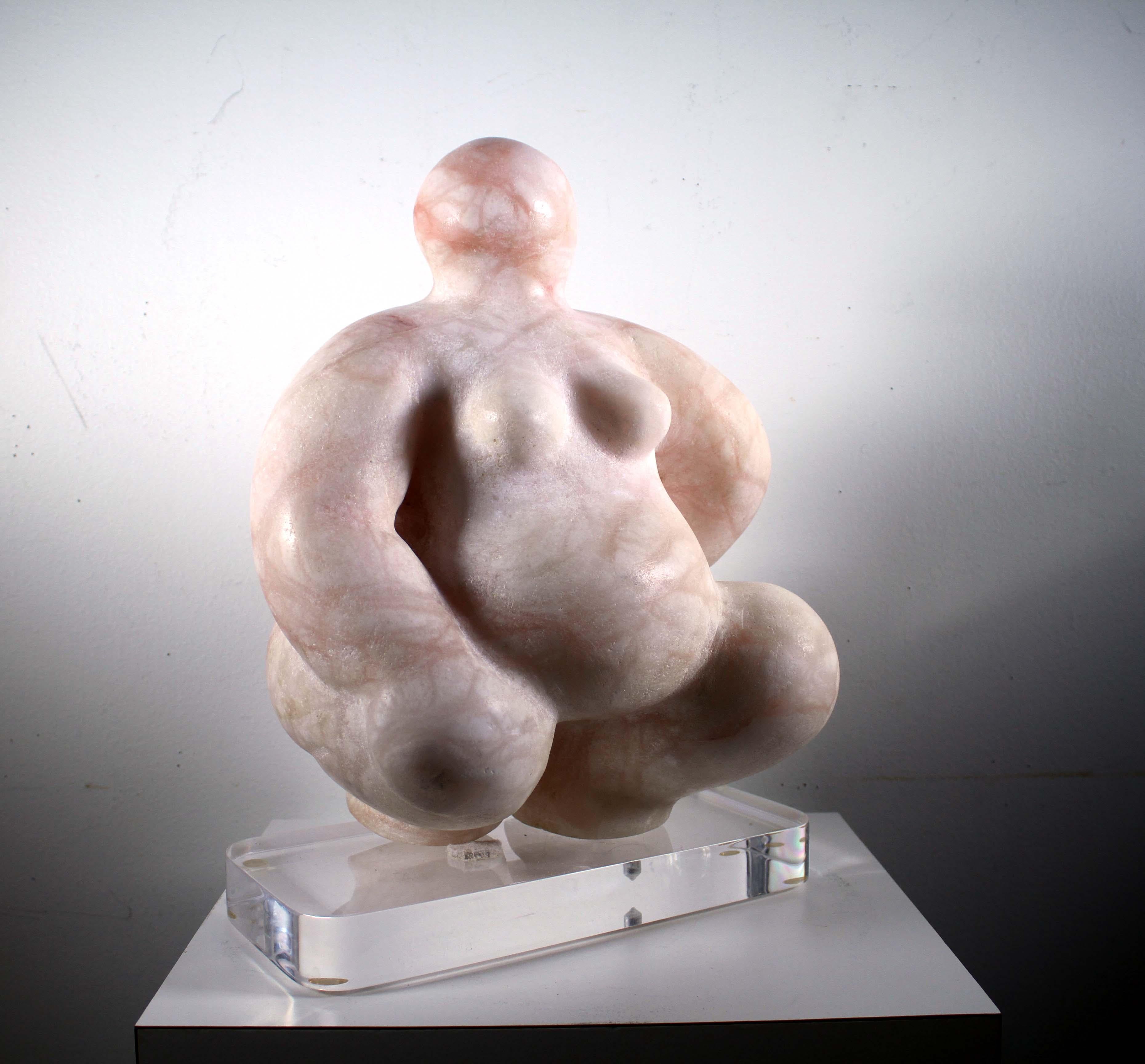 A marvelous, pink marble table sculpture on an acrylic lucite base depicting a nude woman, 