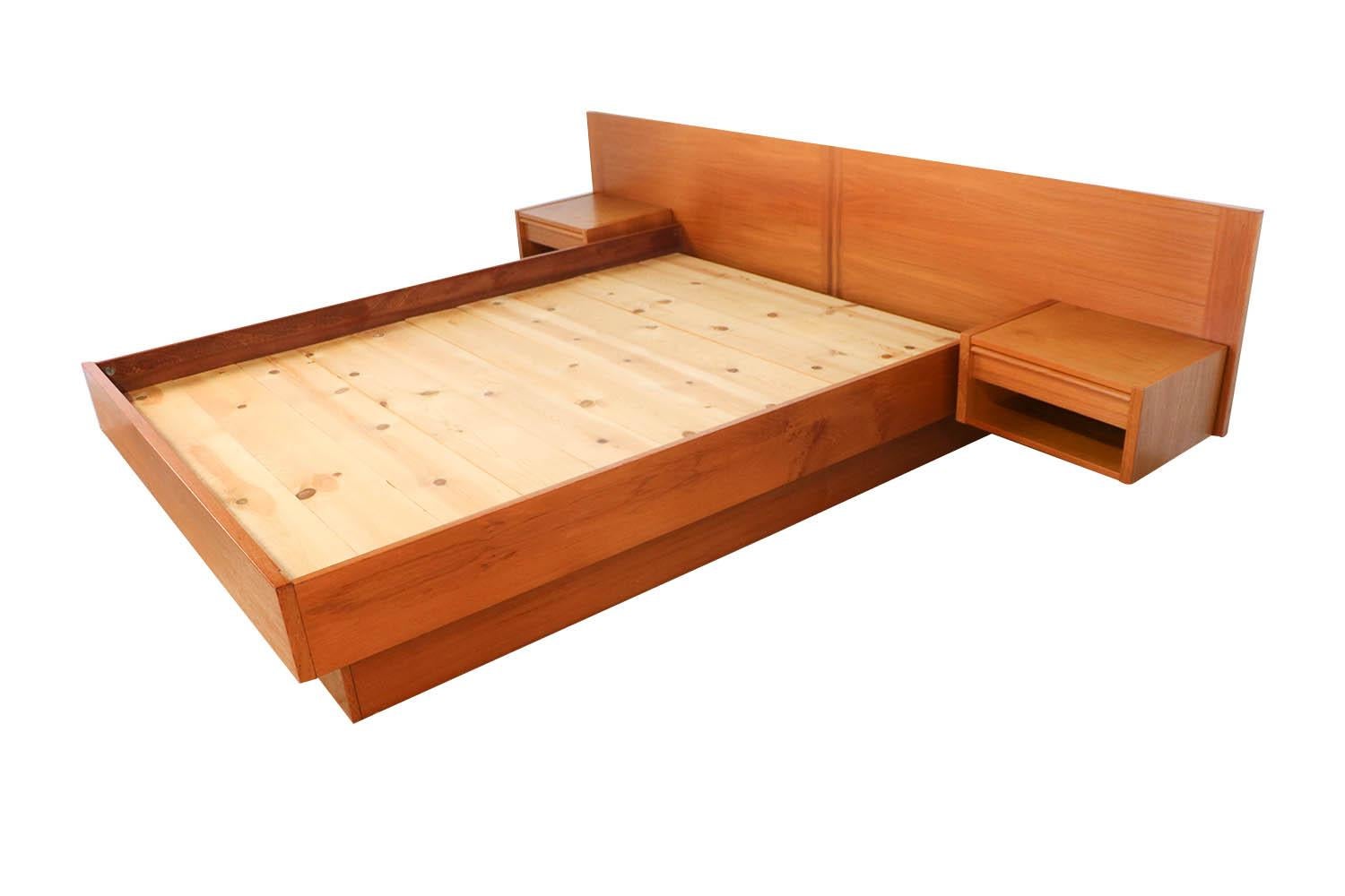 A remarkable Danish teak, midcentury queen platform bed with floating nightstands by Jesper of Denmark. Maker’s label on back “Jesper”, including two sets of slats for extra support. Exceptional construction and style. Featuring a stunning headboard