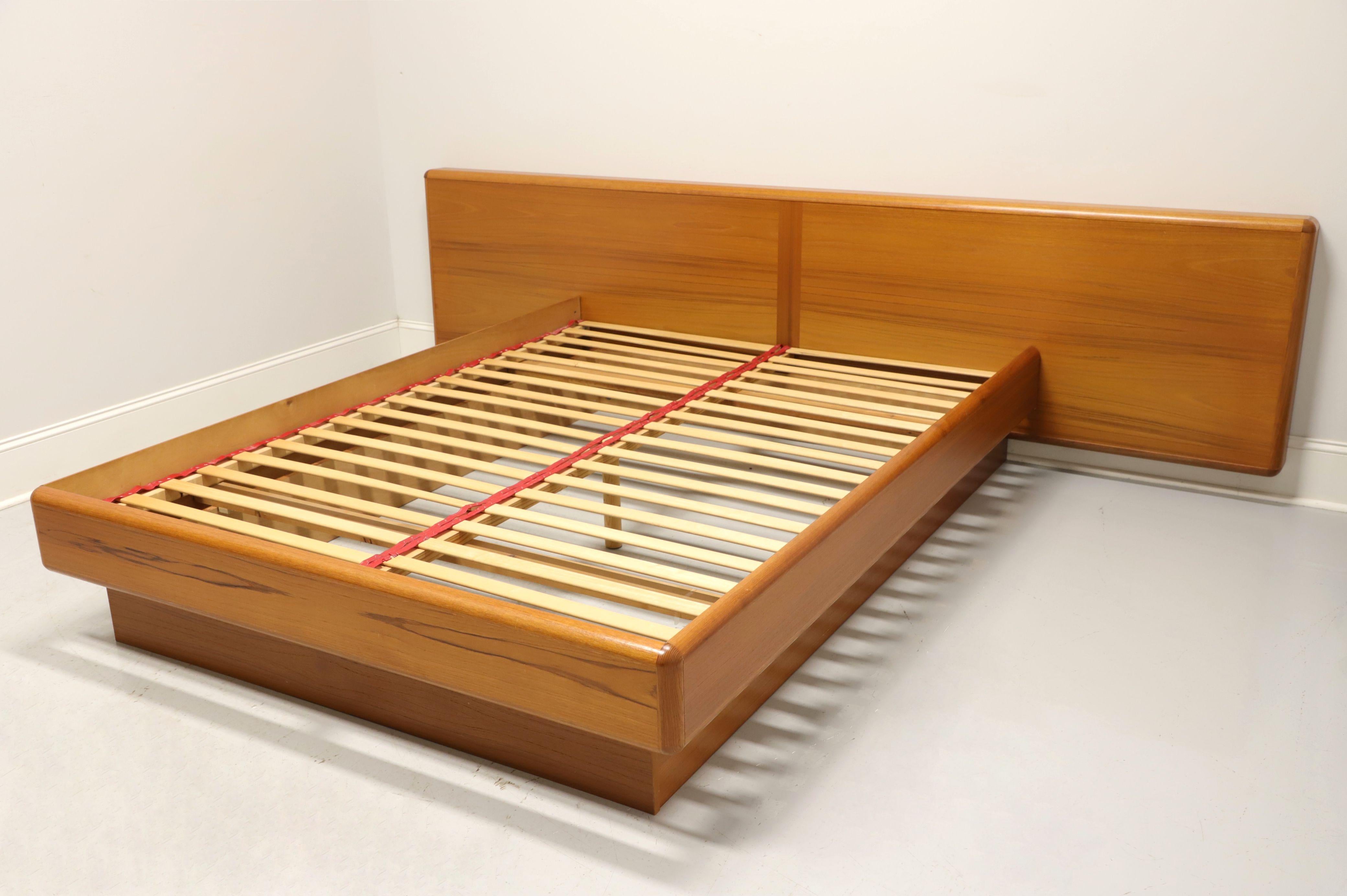 A Danish Mid-Century Modern queen size platform bed by Jesper International. Teak and wood composite with a headboard that extends beyond the attached elevated platform and appears to float. Platform joins together with pin & lock joints and braces