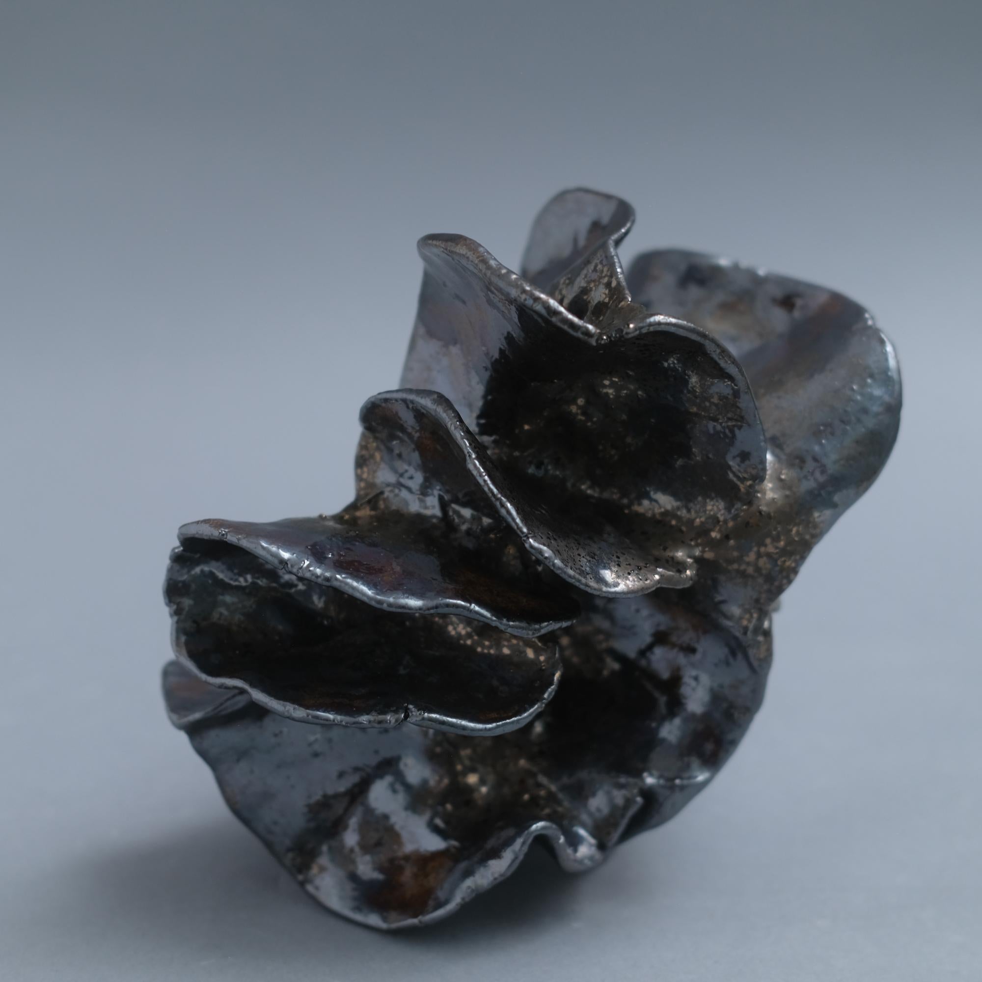 Hand-pitched chrome metallic glazed ceramic sculpture vessel by Jessamyn Go.

Jessamyn Go's work is deeply rooted in the visceral, meditative experience of working with clay. Drawn to the tactile sensation of her hands in the earth, she approaches
