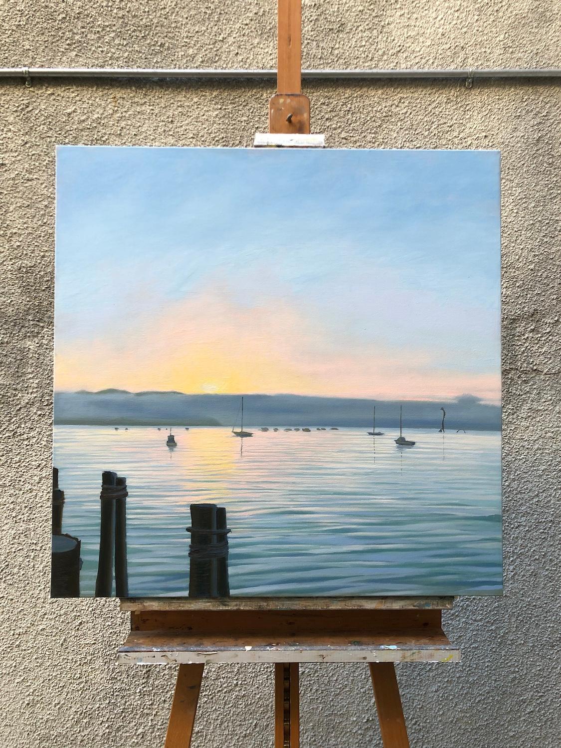 <p>Artist Comments<br />Soft light illuminates a foggy bay as the sun rises over California's central coast. Gentle ripples in the water reflect the pastel sky, while anchored boats float peacefully. Wooden posts in the foreground frame the scene,