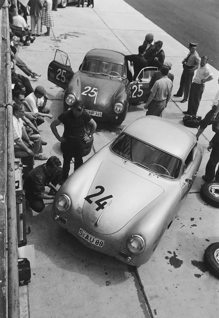 Jesse Alexander Black and White Photograph - Two 356A Factory Cars in Pits, 1000 KM Race
