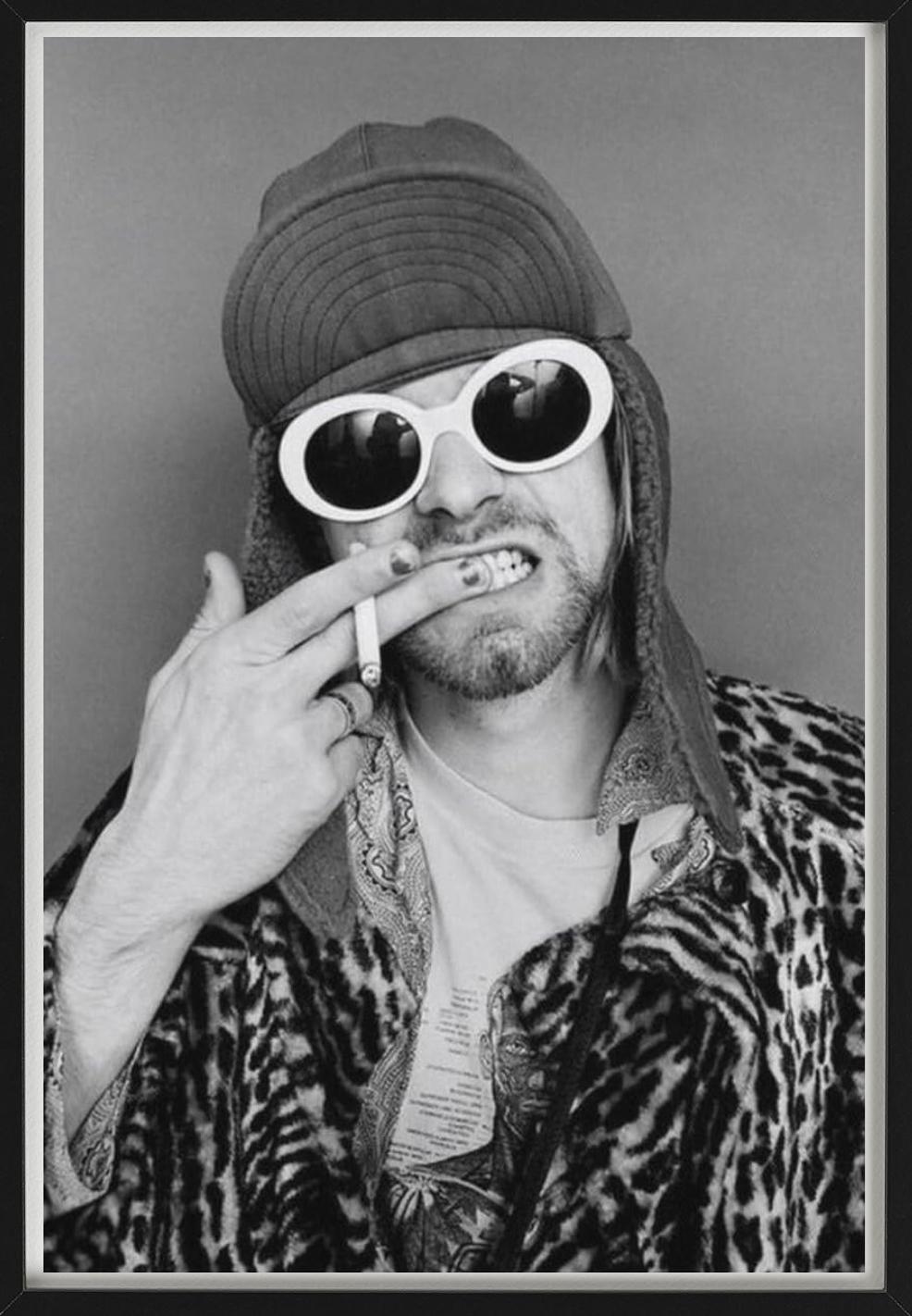 Black and white Portrait of Kurt Cobain in a hat and Sunglasses holding a Cigarette, photographed by Jesse Frohman in 1993.

All prints are limited edition. Available in multiple sizes. High-end framing on request.

All prints are done and signed by