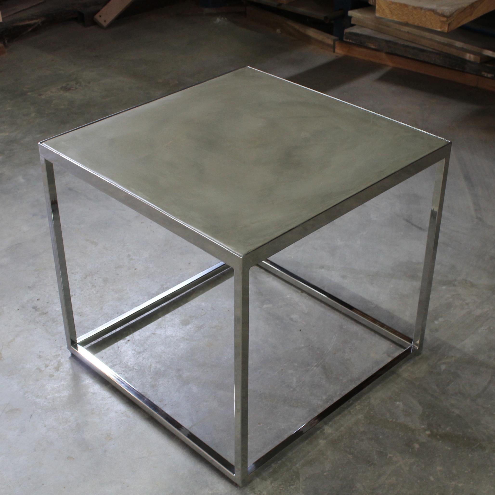 This contemporary design features a rectilinear polished steel frame (customizable) and a polished concrete top, available in any color and other materials as well. Order as shown or in a custom size or finish.

Measurements are: 24