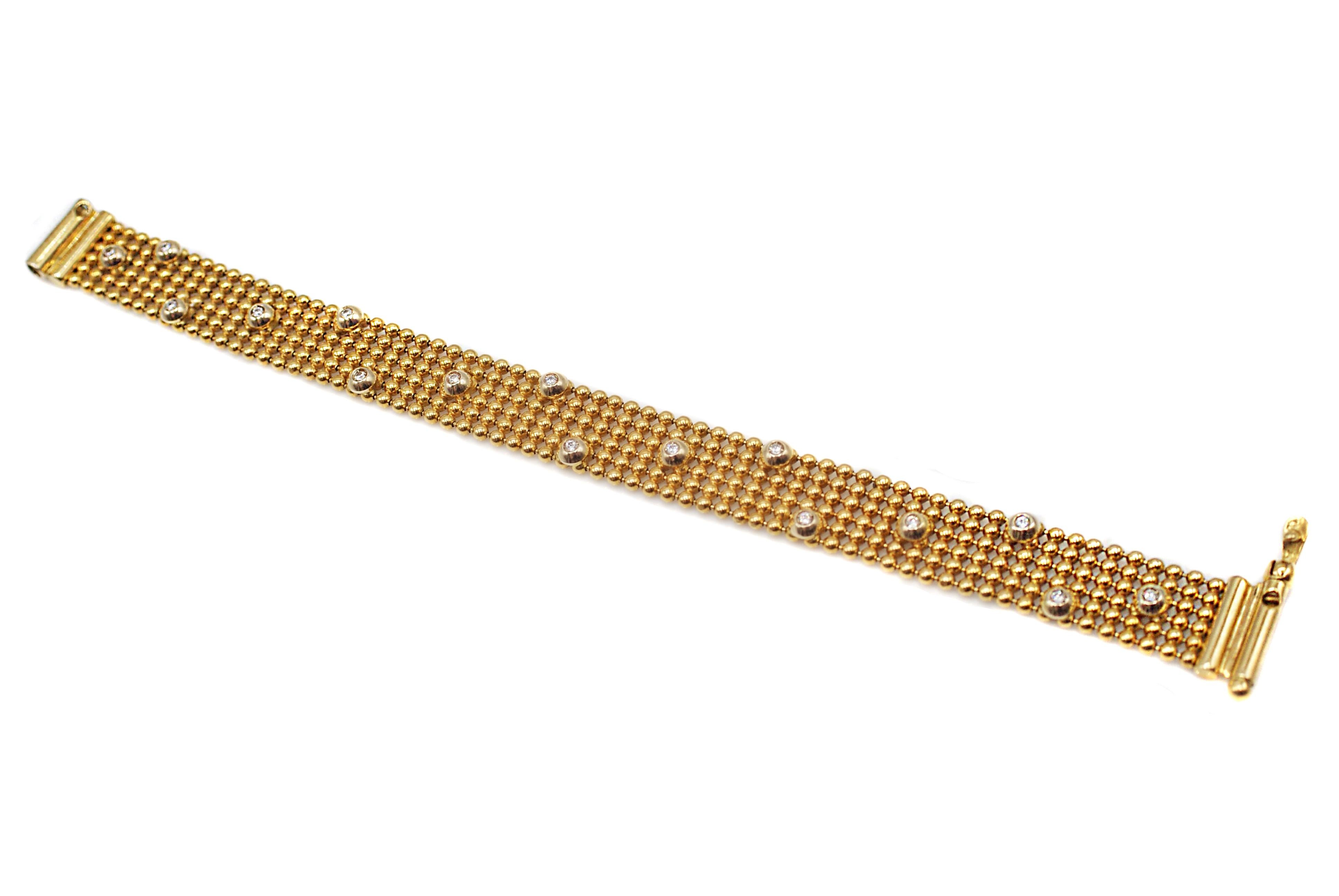 Chic 18 karat yellow gold diamond bracelet, finely handcrafted out of 6 rows of polished round spheres and speckled with bright white round brilliant cut diamonds, bezel set in a dome of polished yellow gold. The smooth finish of this bracelet makes