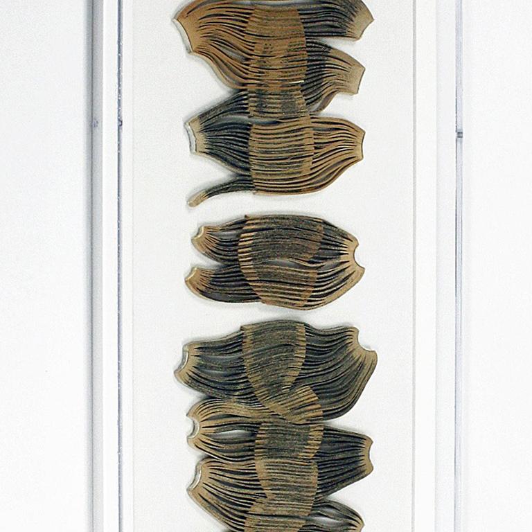 This sculptural wall piece constructed from books and encased in plexiglass is a part of Jessica Drenk's solo exhibition 