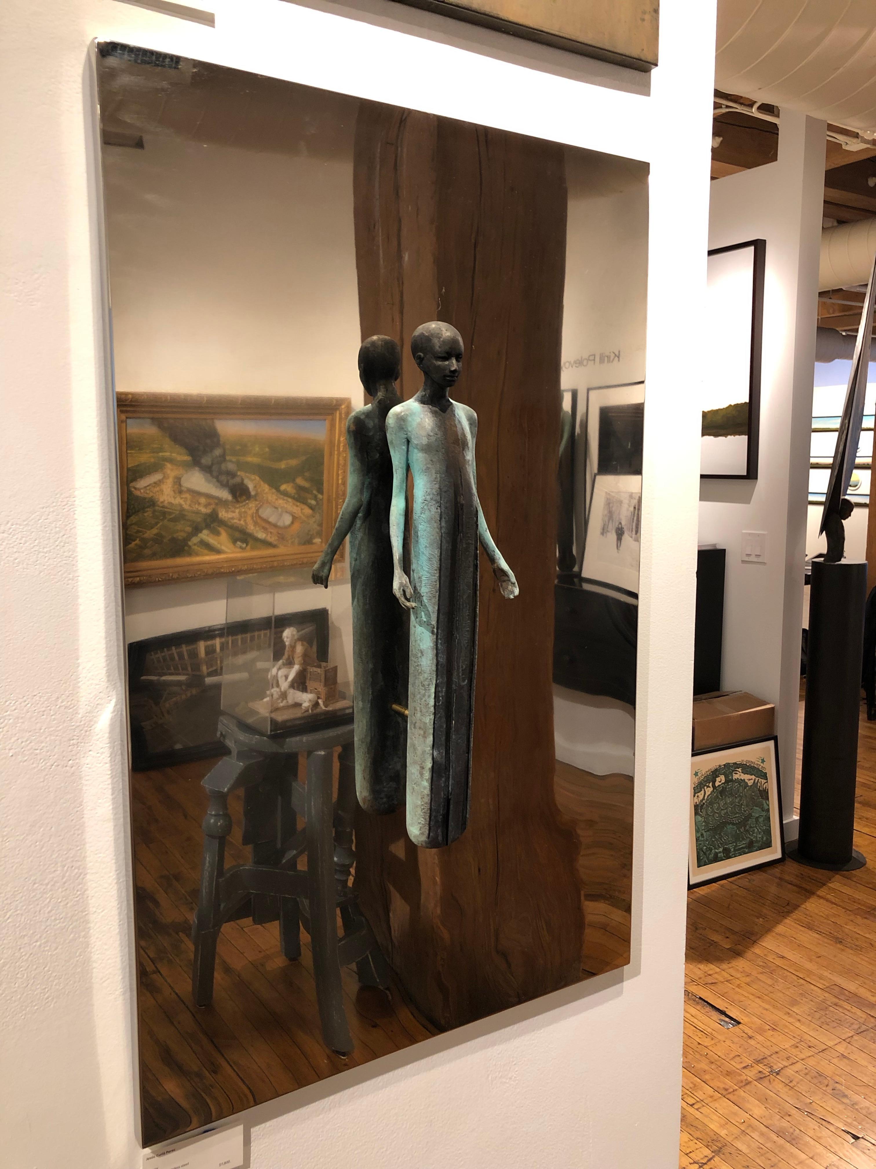 This bronze wall sculpture is mounted on a polished stainless steel surface.  The sculpture appears to float in mid-air.  The the abstracted figure is patinated in green verdigris and brown rust tones.

Jesús Curiá Perez
Library
bronze and stainless