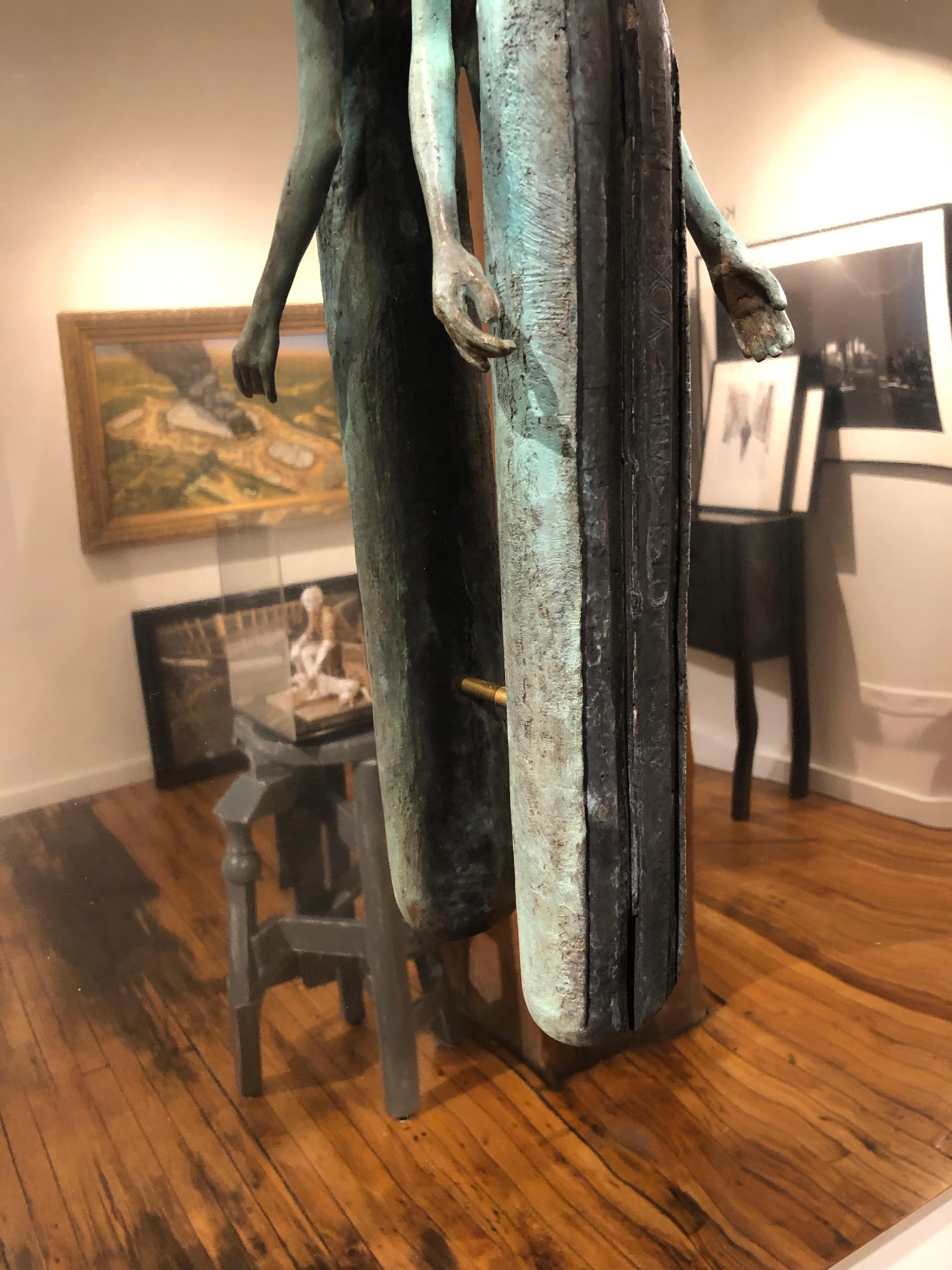 This bronze wall sculpture is mounted on a polished stainless steel surface.  The sculpture appears to float in mid-air.  The the abstracted figure is patinated in green verdigris and brown rust tones.

Jesús Curiá Perez
Library
bronze and stainless