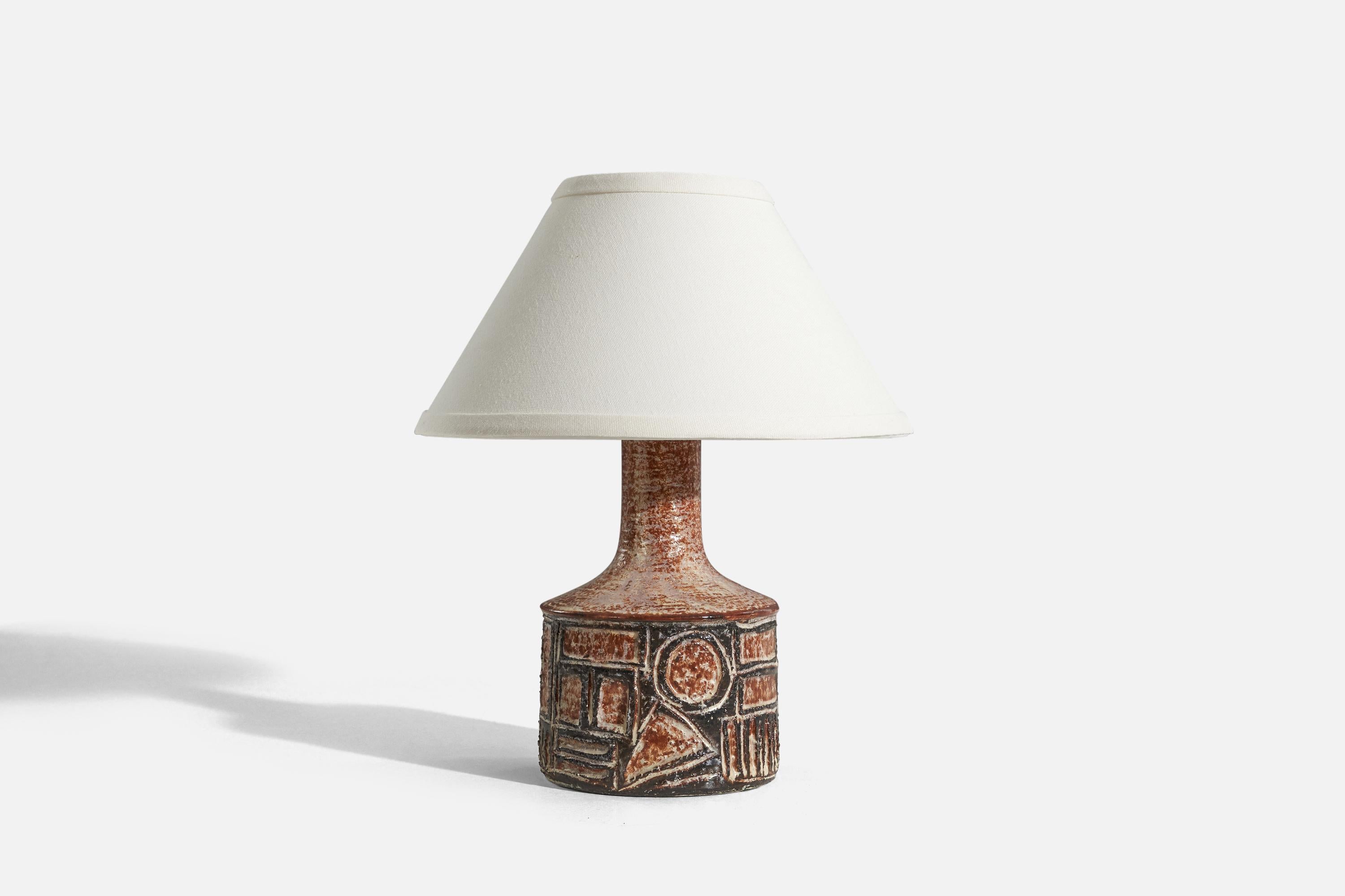 A black and red, glazed stoneware table lamp designed and produced by Jette Hellerøe, Denmark, 1960s.

Sold without lampshade. 
Dimensions of Lamp (inches) : 9.875 x 5 x 5 (H x W x D)
Dimensions of Shade (inches) : 4.25 x 10.25 x 6 (T x B x