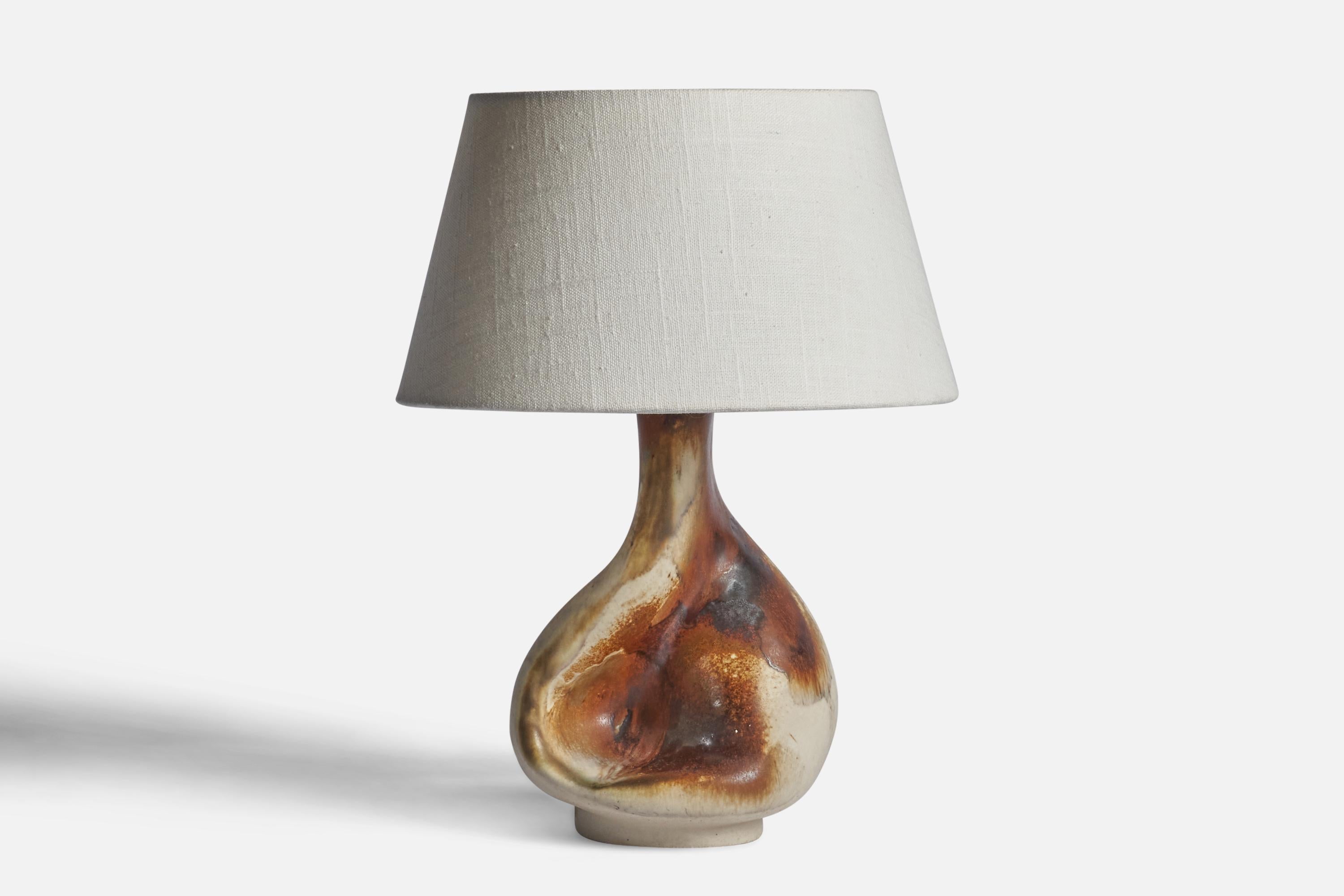 A brown and beige-glazed stoneware table lamp designed by Jette Hellerøe and produced by Axella, Denmark, c. 1960s.

Dimensions of Lamp (inches): 10.35” H x 5.75” Diameter
Dimensions of Shade (inches): 7” Top Diameter x 10” Bottom Diameter x