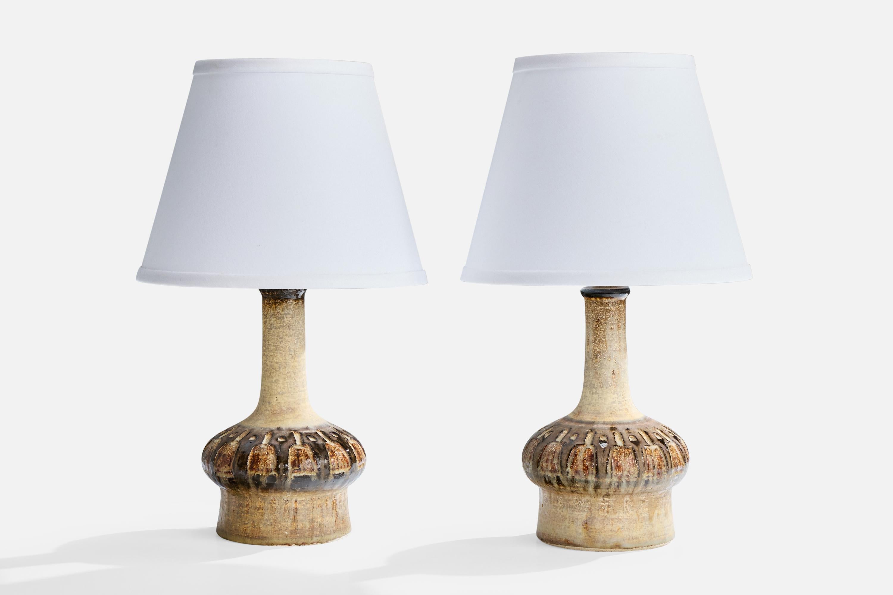 A pair of ceramic table lamps designed and produced by Jette Hellerøe, Denmark, c. 1960s.

Dimensions of Shade (inches): 6” Top Diameter x 10” Bottom Diameter x 8” Height

Dimensions of Lamp with Shade (inches): 17” Height x 10” Diameter

Dimensions