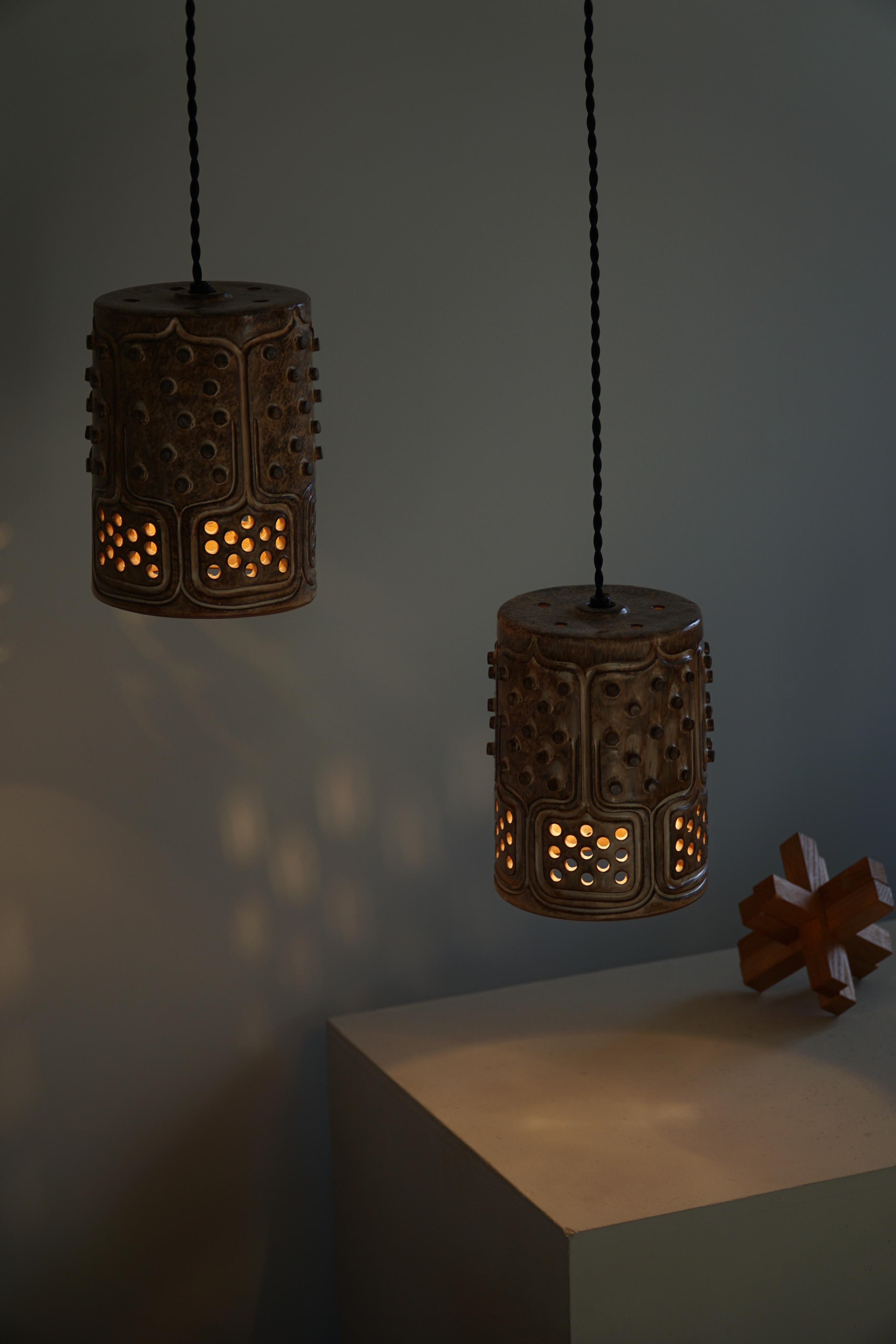 A pair of organic shaped cylinder pendant lamps in a good vintage condition. The lamp is handcrafted which makes the different shapes unique. The experimental shape and color of the lamp makes it a great object for almost every home creating a pop