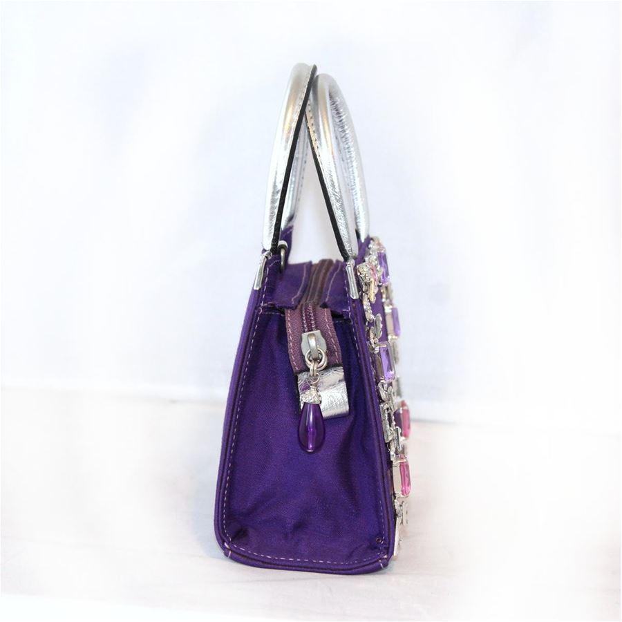 Textile Purple color Wonderful metal crystals and swarovski applications Double handle silver color Zip closure Can be carried crossbody too Cm 15 x 13 x 7 (5.9 x 5.1 x 2.7 inches)
