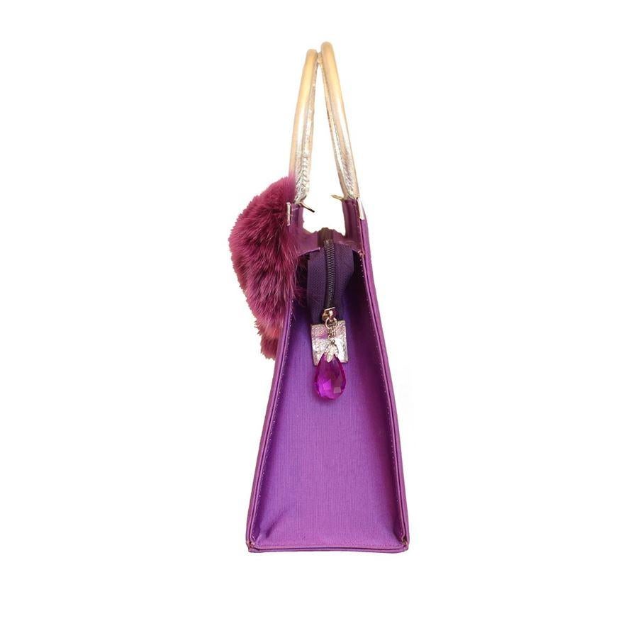 Textile Purple color Real fox fur White inserts Wonderful swarovski crystals applications Silver colored leather handles Can be carried crossbody too Internal zip pocket Cm 32 x 24 x 105 (12.5 x 9.44 x 4.13 inches)
