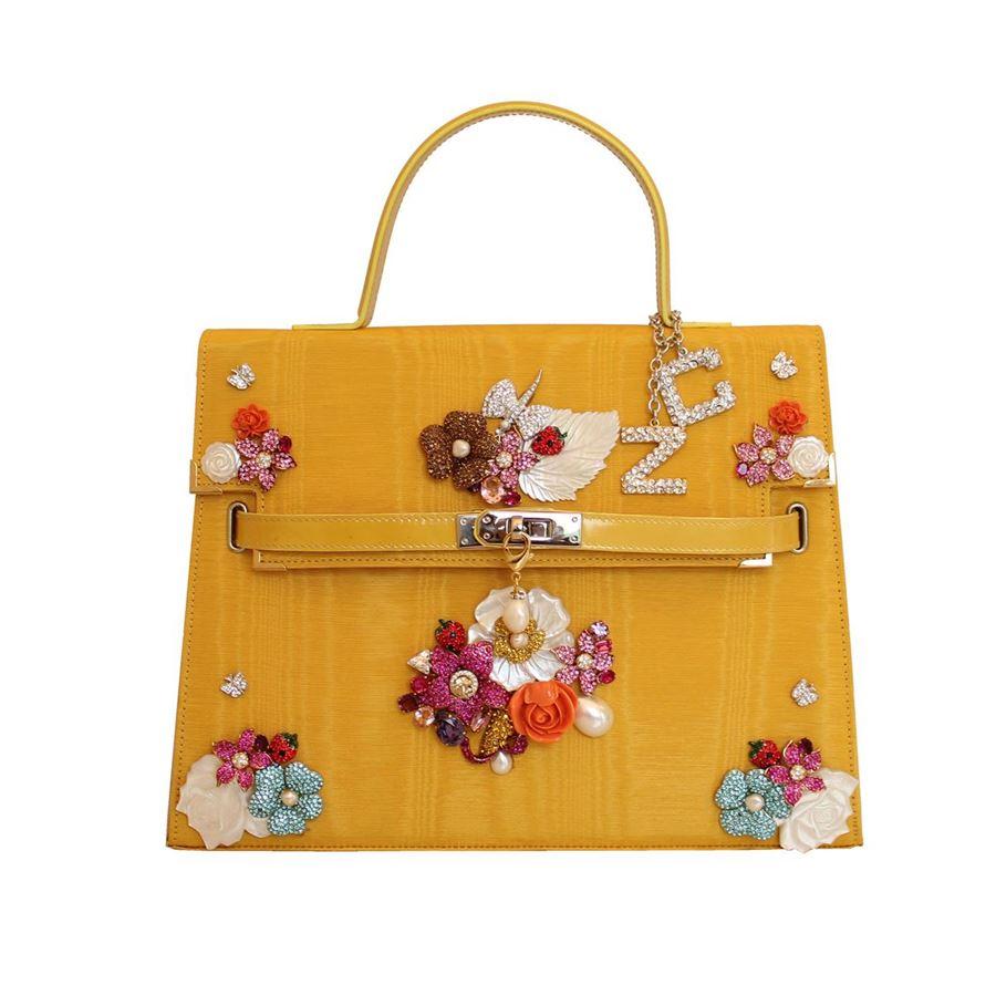 Textile Yellow color Floral theme Wonderful swarovski crystals resins and faux pearls Leather handle Can be carried crossbody too Internal zip pocket Cm 32 x 24 x 105 (12.5 x 9.44 x 4.13 inches)
