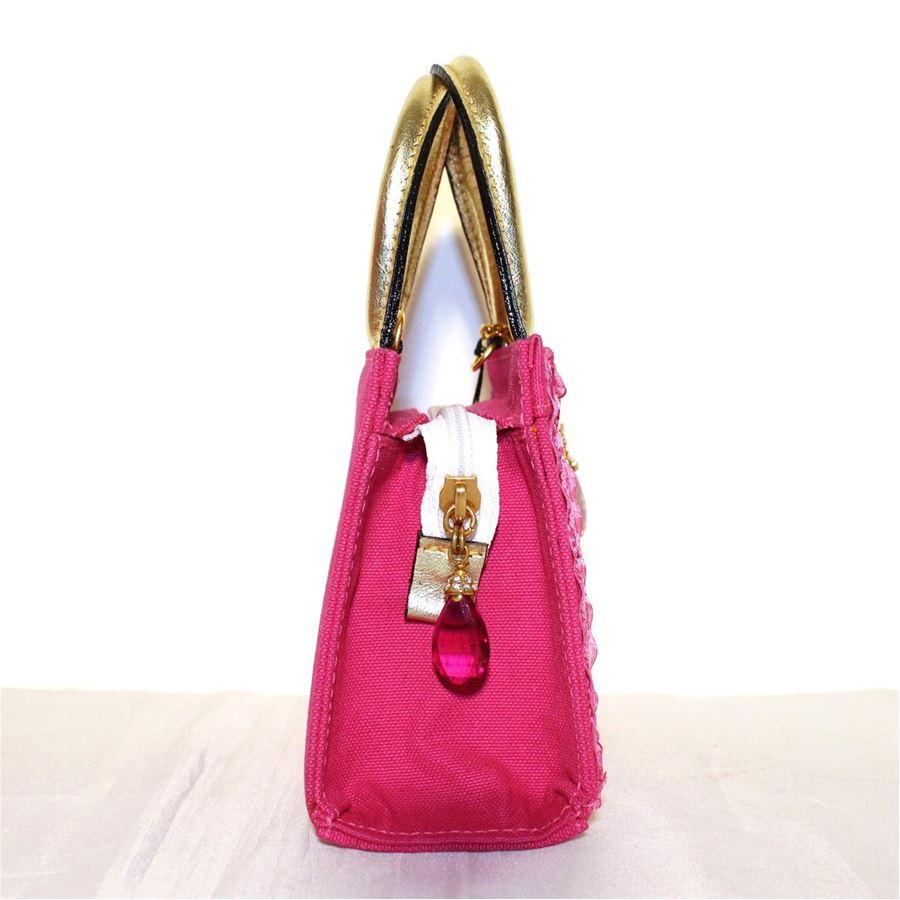 Fuchsia textile Wonderful metal sequins crystals and swarovski applications Multicolored abstract pattern Gold colored leather handles Zip closure Can be carried crossbody too Cm 15 x 13 x 7 (5.9 x 5.1 x 2.7 inches)
