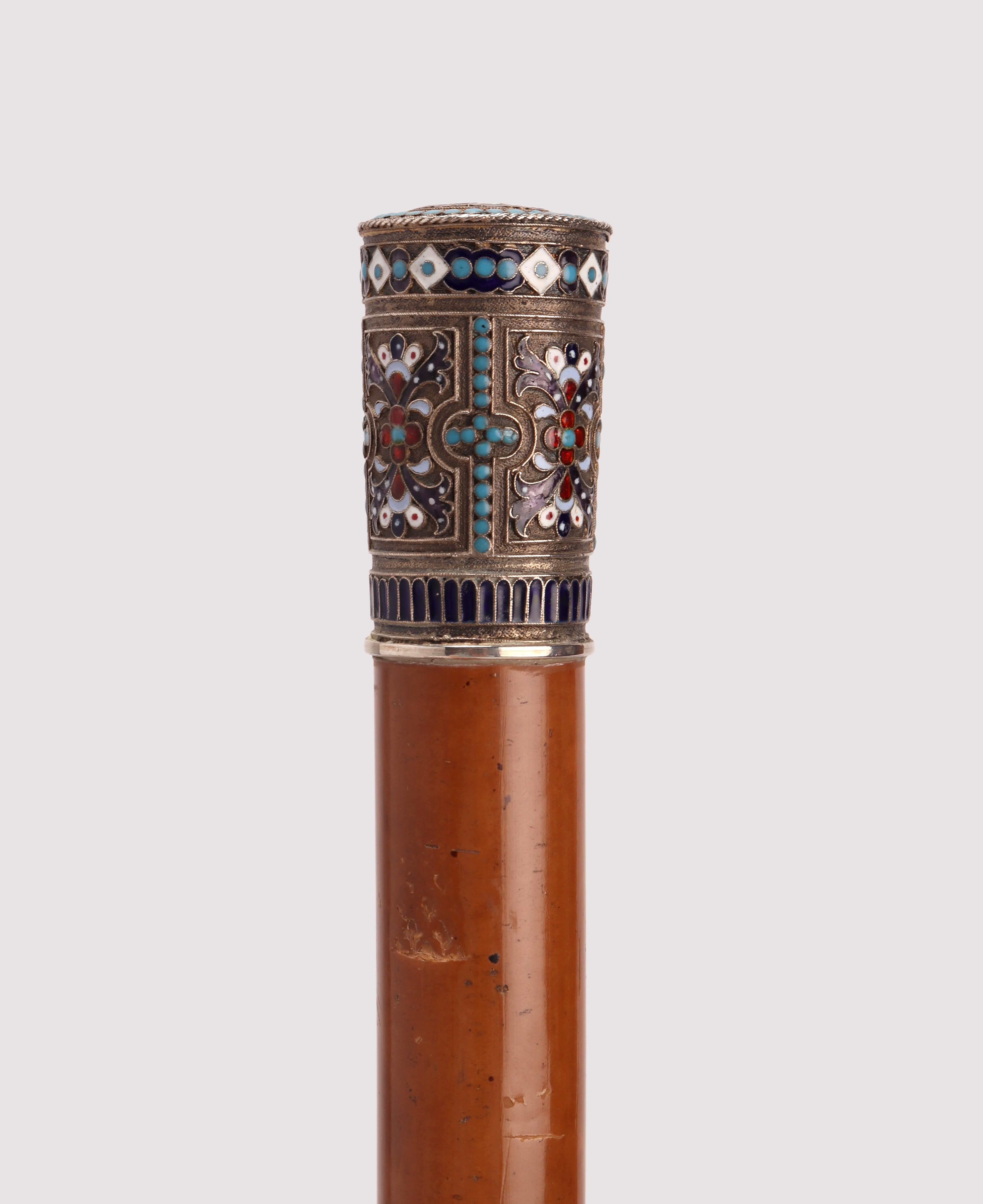 Jewel walking stick. The handle is entirely decorated with Russian style geometrical motive enriched by different colors of opaque enamels by using the cloisonné technique. It shows the Moscow hallmark, the number 84, and the initials of the jewel
