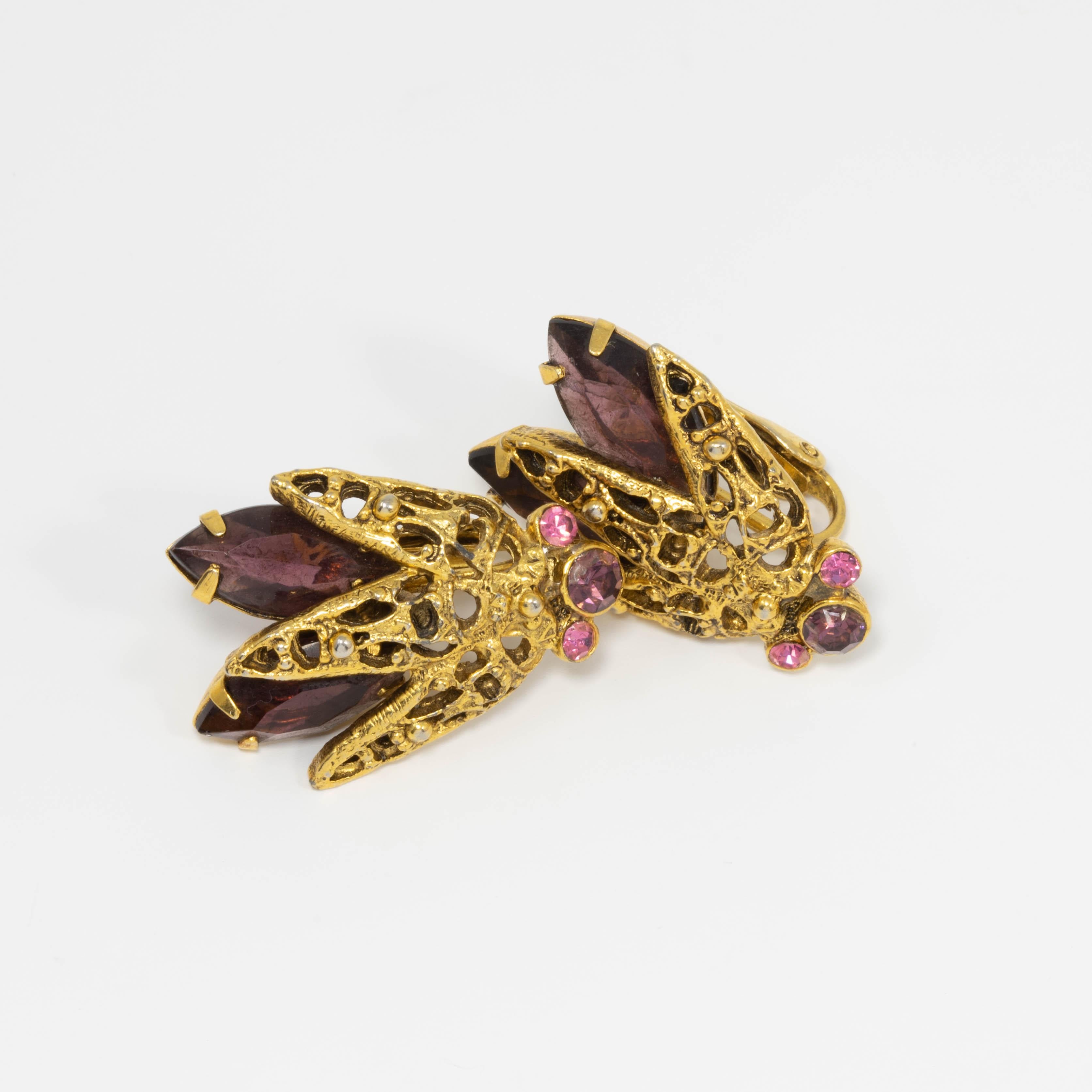 A pair of exquisite flies! Each features an accented, gold-tone body and an assortment of amethyst and rose crystals.

Vintage clip on closure. Circa early to mid 1900s.