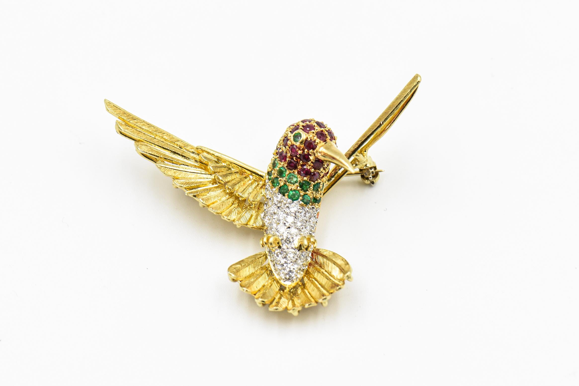 Finely made 18k yellow gold hummingbird brooch featuring etched wings with a diamond body, ruby head and emerald collar and eye.  This brooch is marked 750.  I believe it was made in Italy in 1960 or 1970s.