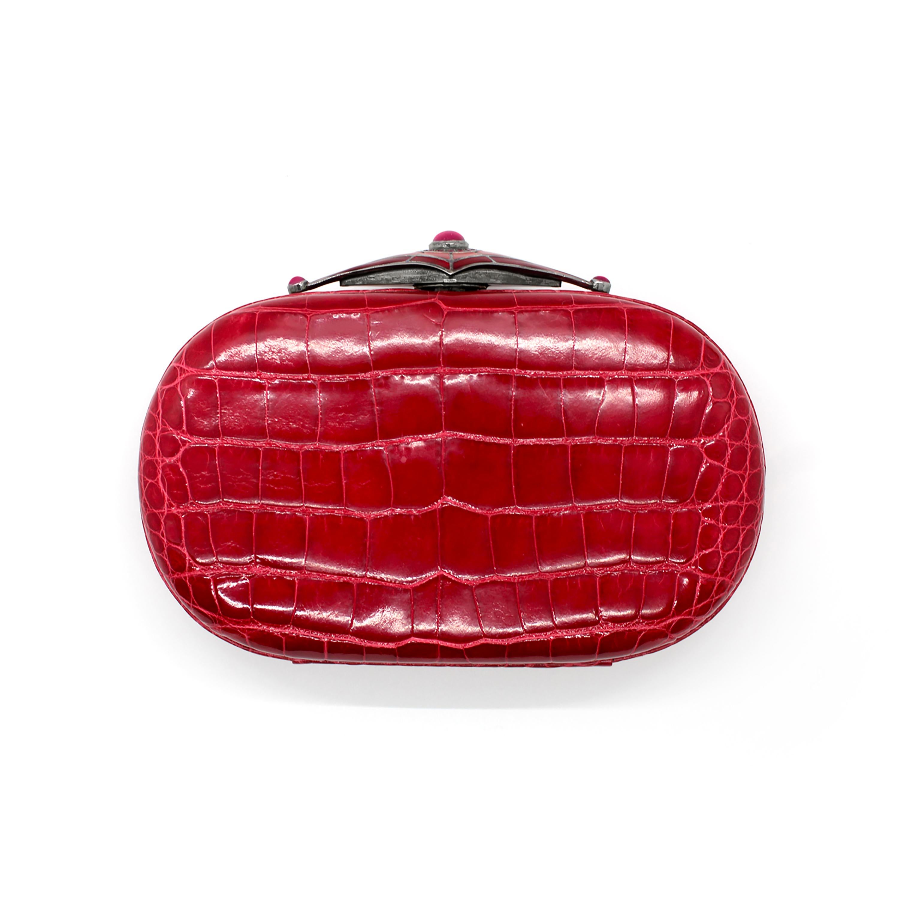 One of a kind, 20th-century sterling silver Guilloché enamel clasp red exotic alligator skin Minaudière
Silver Clasp pave set with red rubies weighing 1.50 carats, blackened
Bezel set cabochon ruby weighing 6 carats
11