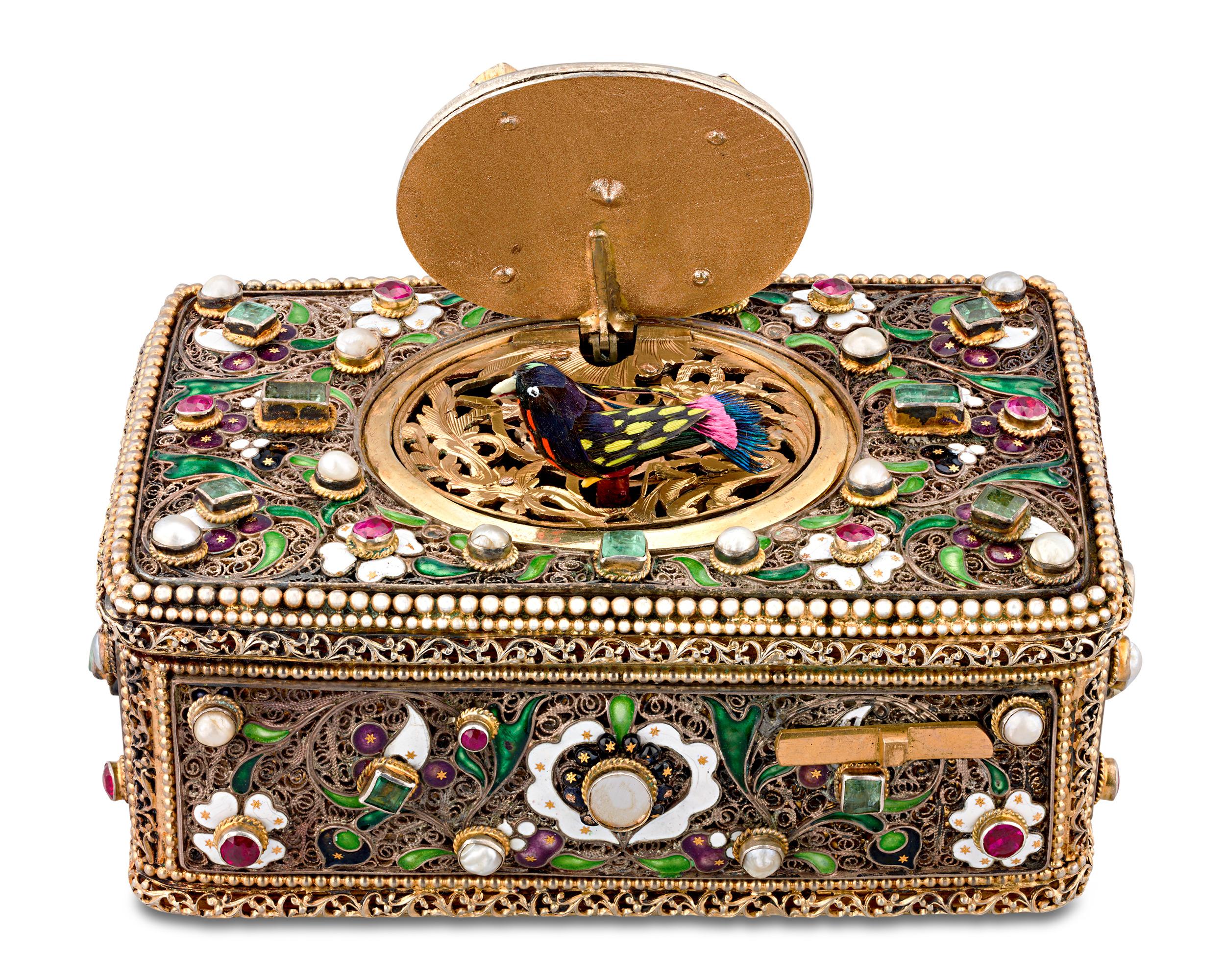 Jeweled Singing Bird Box
19th-century

This remarkable Swiss singing bird box stands apart from the finest of its kind, featuring a rare embellishment—genuine gemstones. Emeralds form the greenery in the foliate design, complemented by mabé pearls