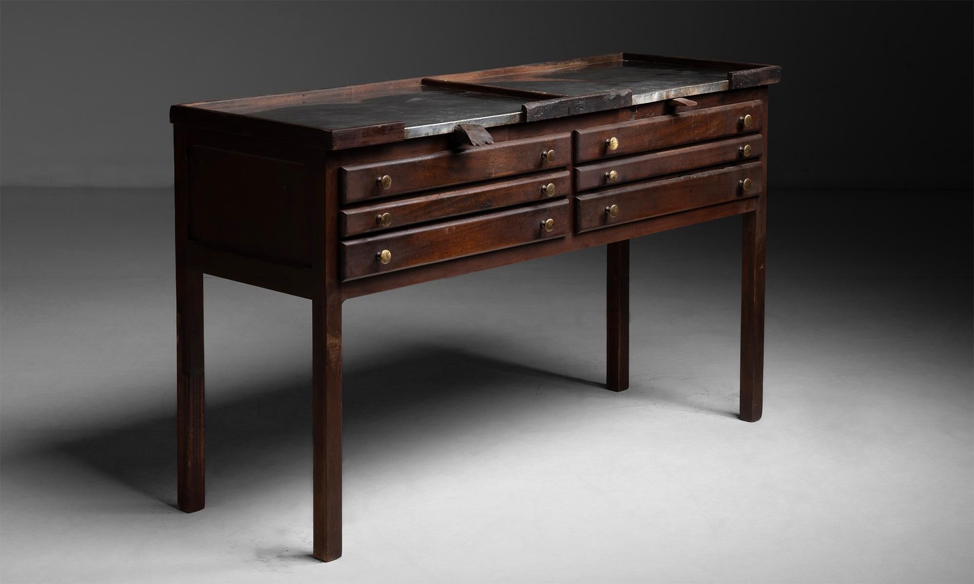 Jeweler's work table

France circa 1930

Constructed in mahogany with metal surface and (6) narrow drawers.

Measures: 59.75”L x 23”d x 36.5”h.