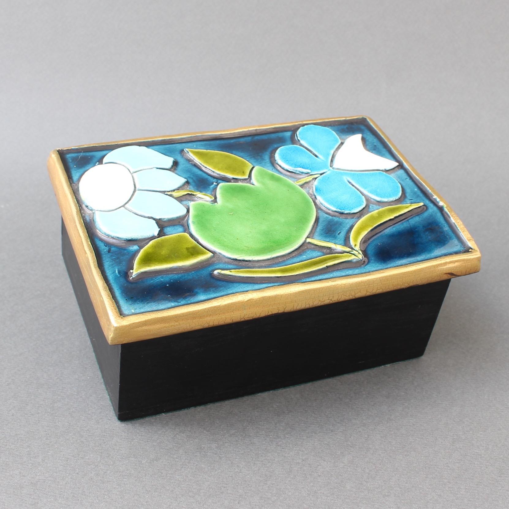 Jewellery box with decorative ceramic lid by François Lembo 'circa 1960s'. Art Deco style raised floral motif with blue, green and white over a stunning blue base lid. The decorative surround is in Lembo's trademark gold crackle. The lid tops a