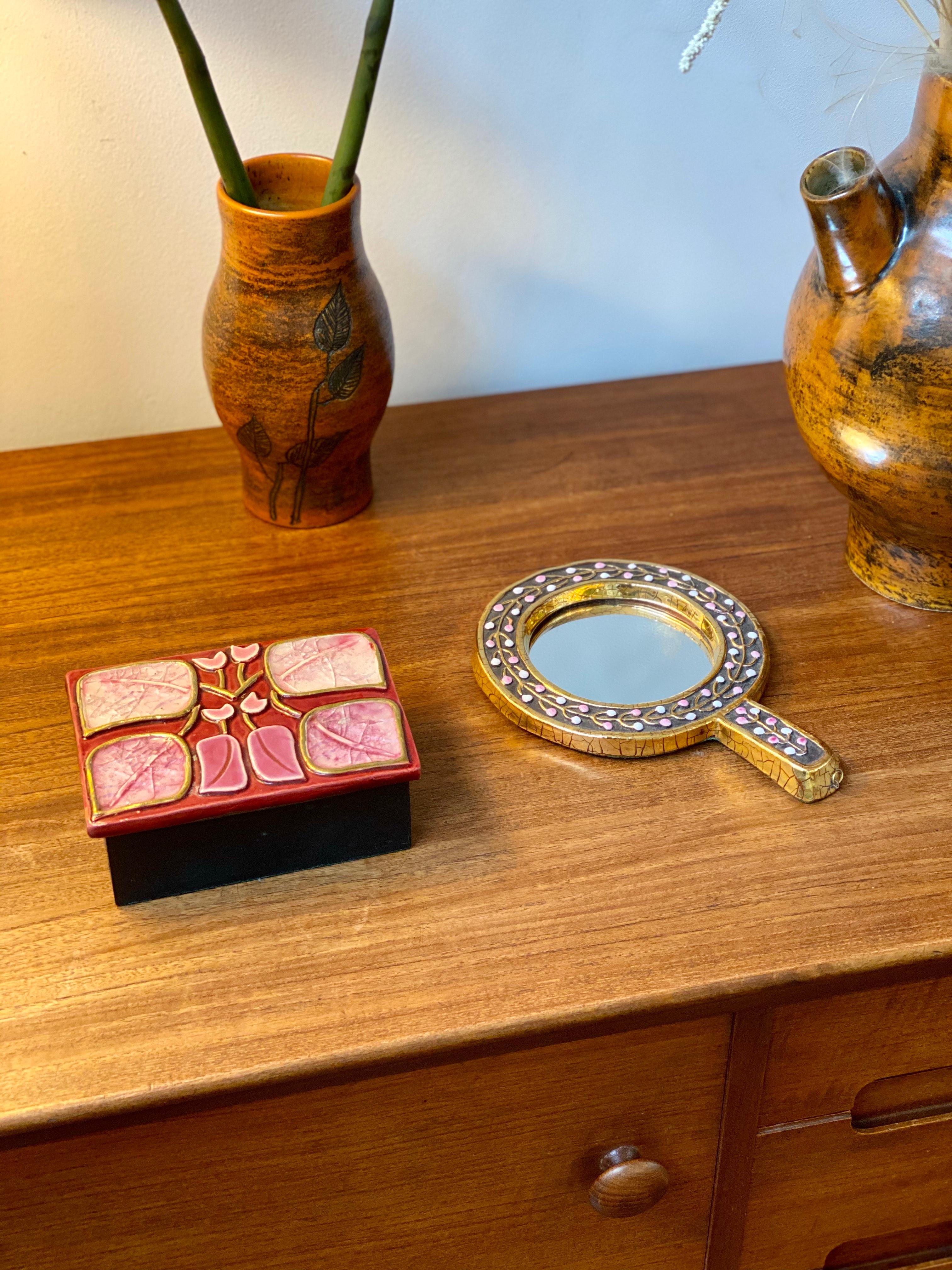 Decorative jewelry box with enamel lid and flower motif by François Lembo (circa 1960s). Stylised pink and white highlighted leaves outlined in gold-coloured craquelure cover the rectangular-shaped decorative box. It is at once a visually stunning