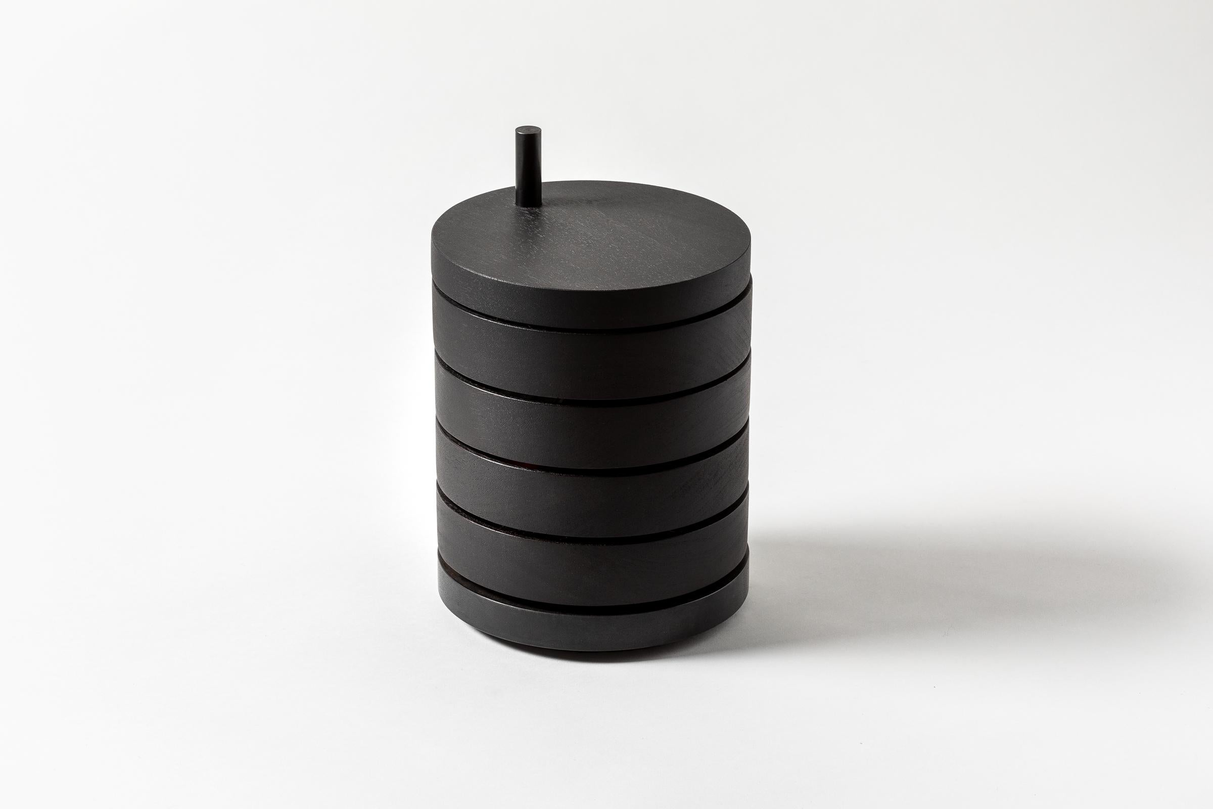 Jewelry Box 1 features four rotating trays that swing 360 degrees with the tap of a finger, lined with suede leather and grounded by a solid steel or bronze base. A stunning sculptural presence with a shapeshifting silhouette.

Red inner lining. 