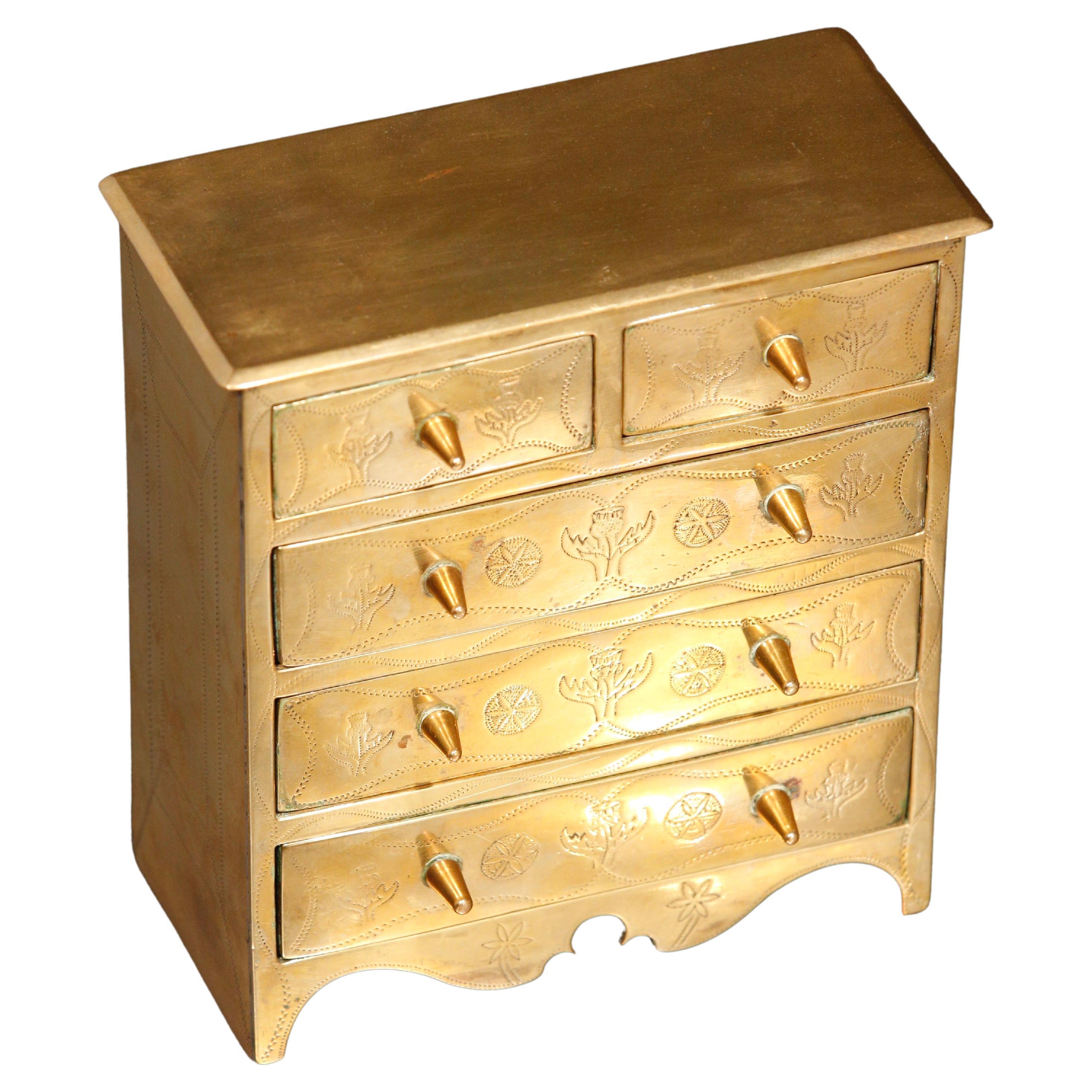 Chest of Drawers Jewelry Box Apprentice Chest Brass Engraved 

Solid brass apprentice chest of drawers, chest with 5 working drawers all with stylized thistle engraved decorations

Slight tarnishing in areas.  
